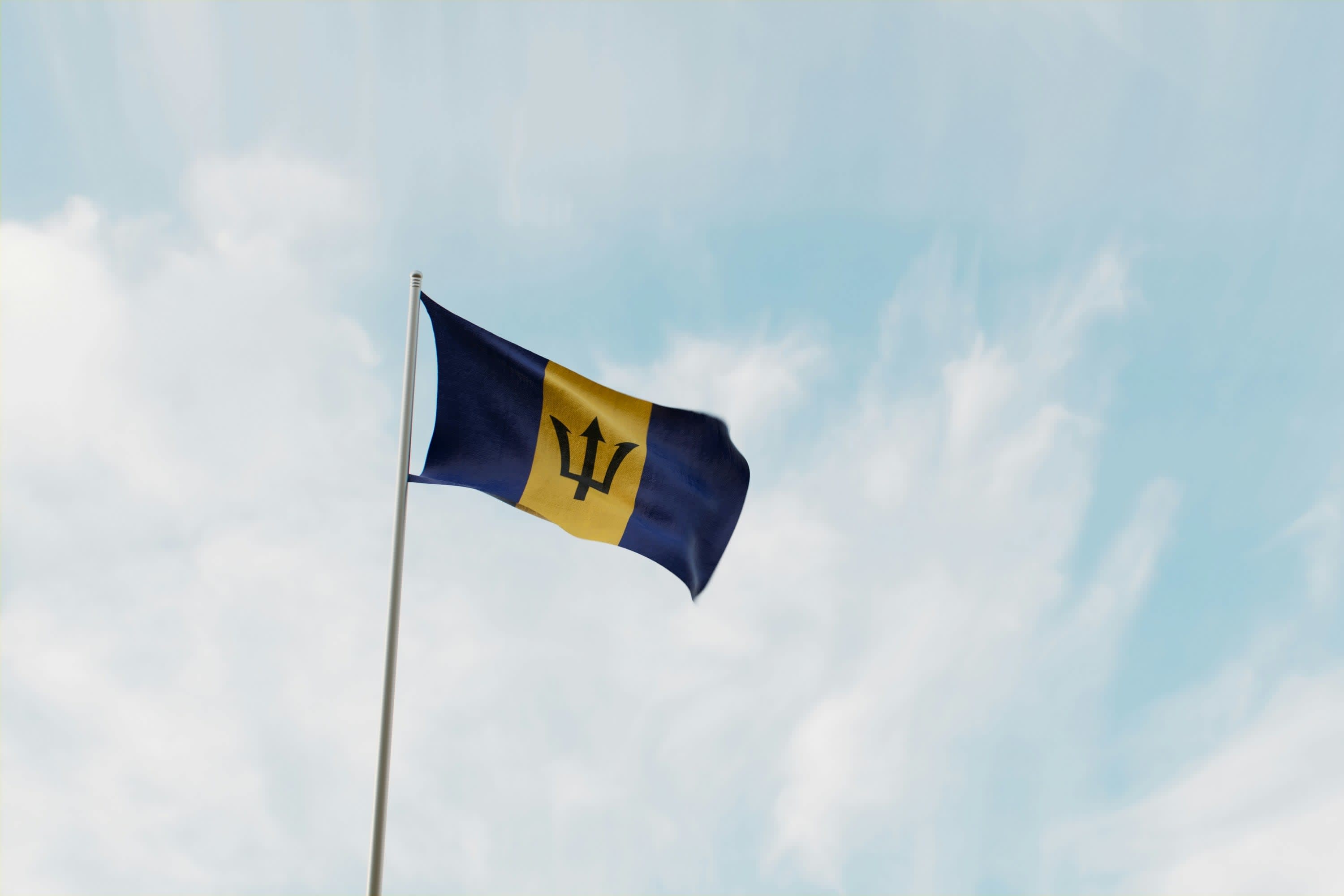 The Bajan flag against a blue sky