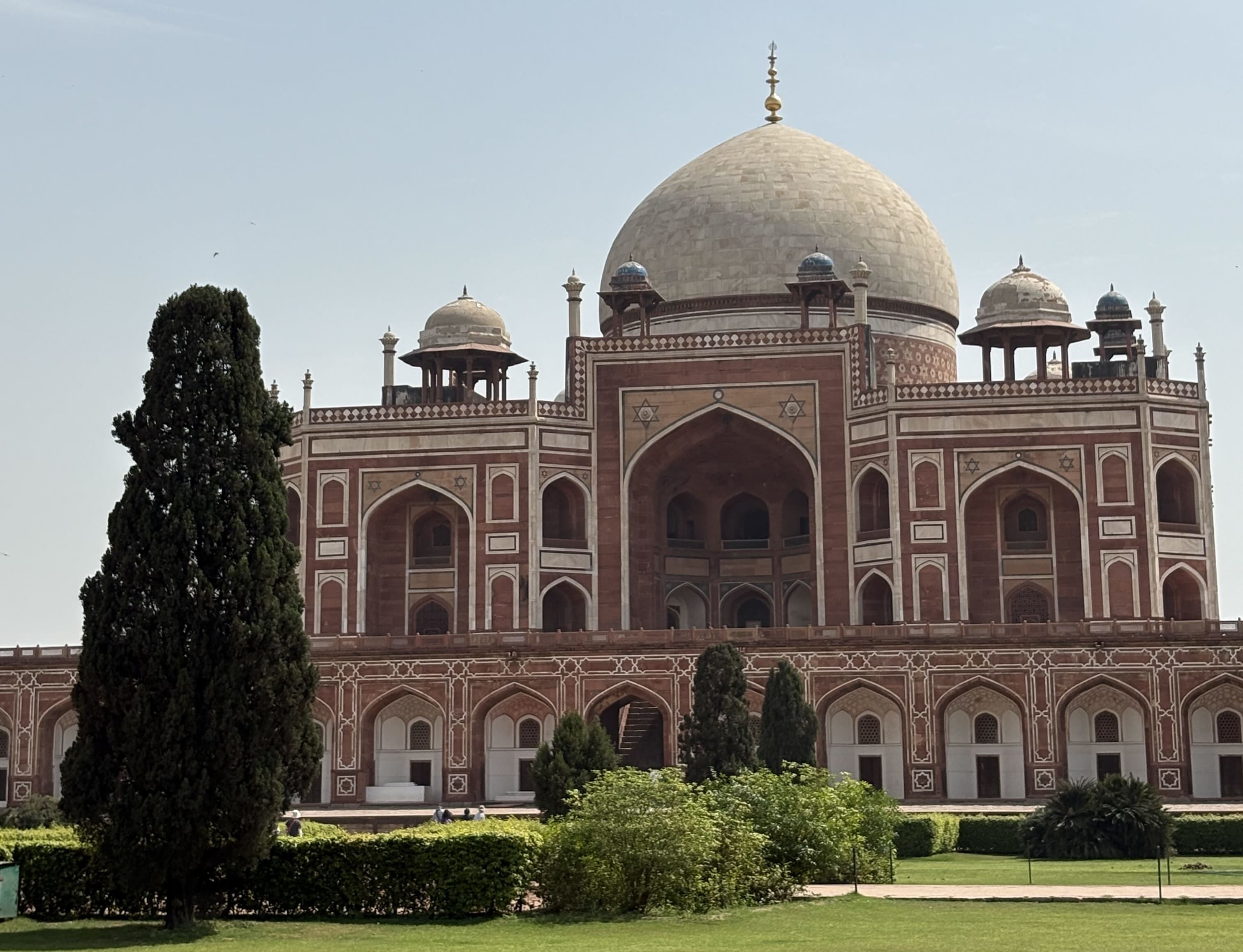 an elaborate domed structure on a grassy lawn