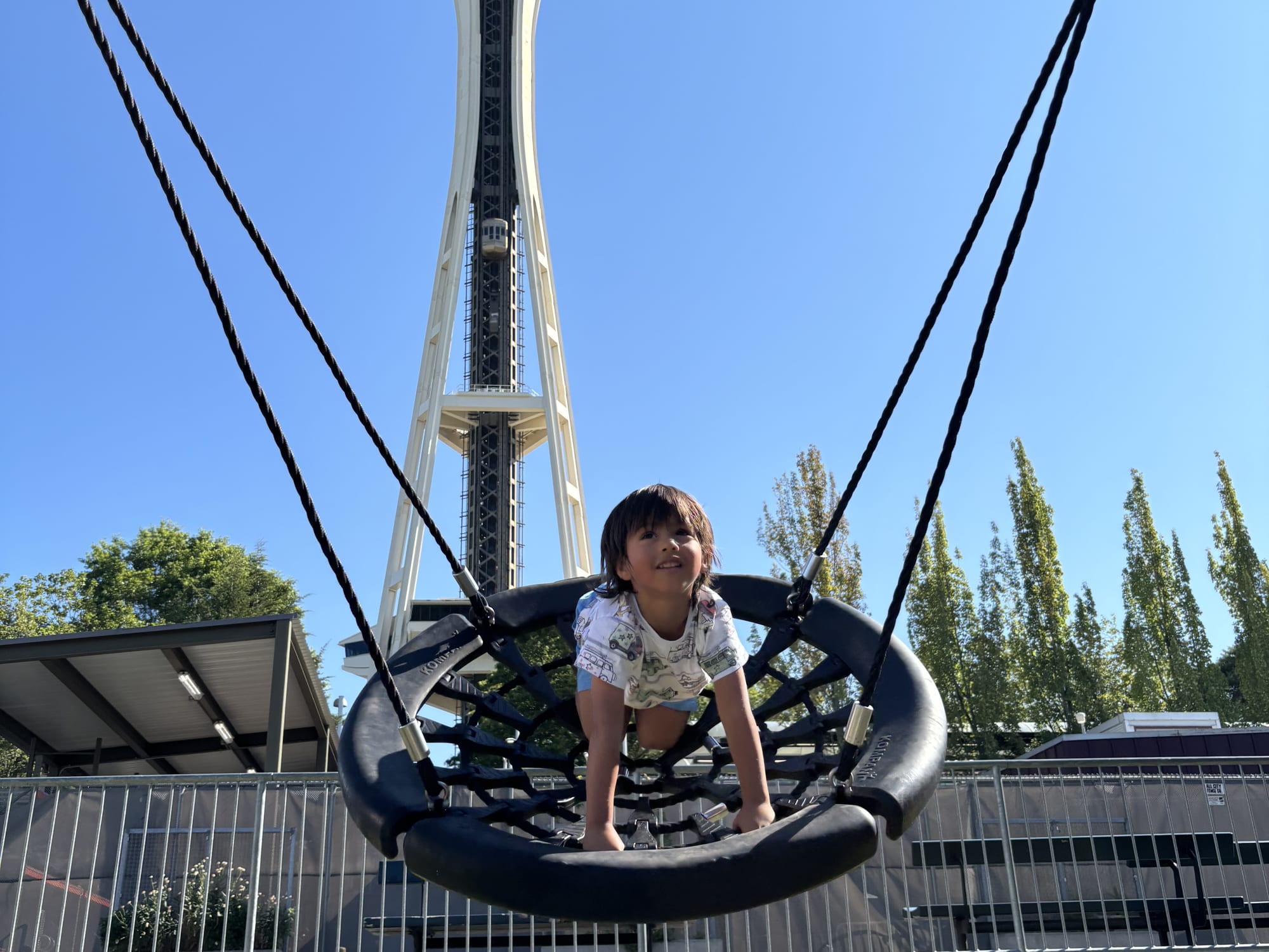 A kid at "Artists at Play" Playground and Space Needle.