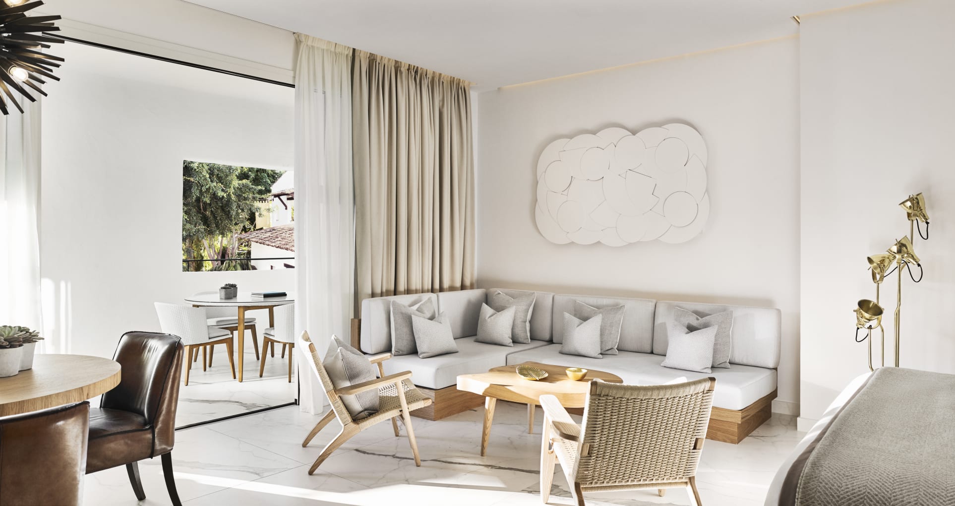 a sleek hotel suite at Nobu Hotel Marbella with gray and white furniture