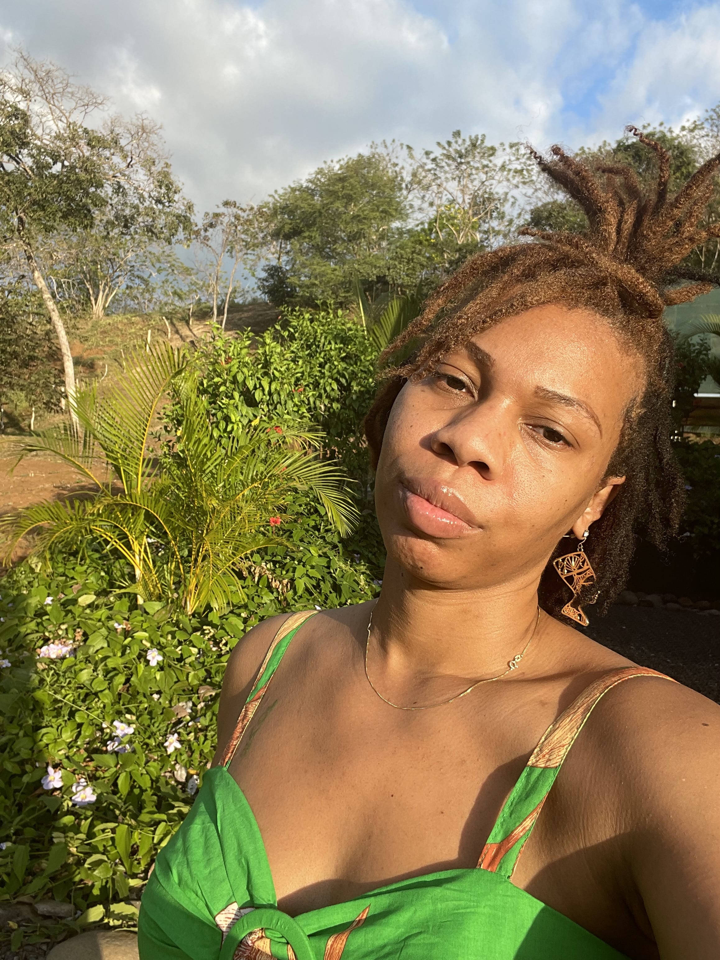 Picture of Daniele in green dress with plants in view