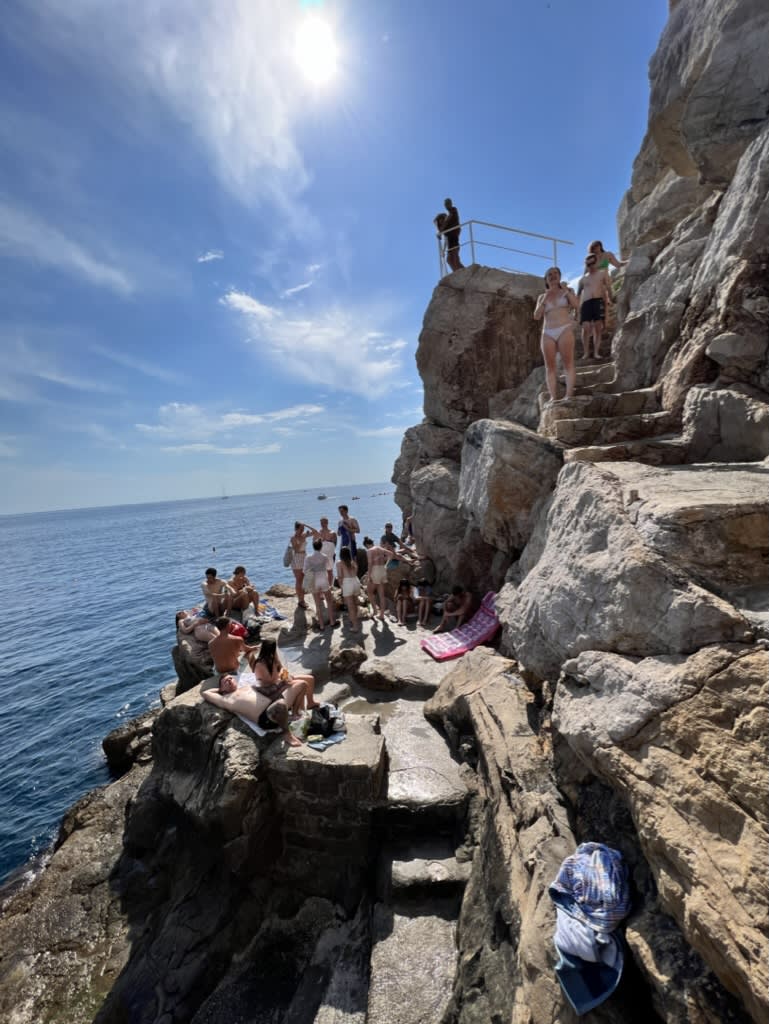 People hanging out on a plain area of a hill