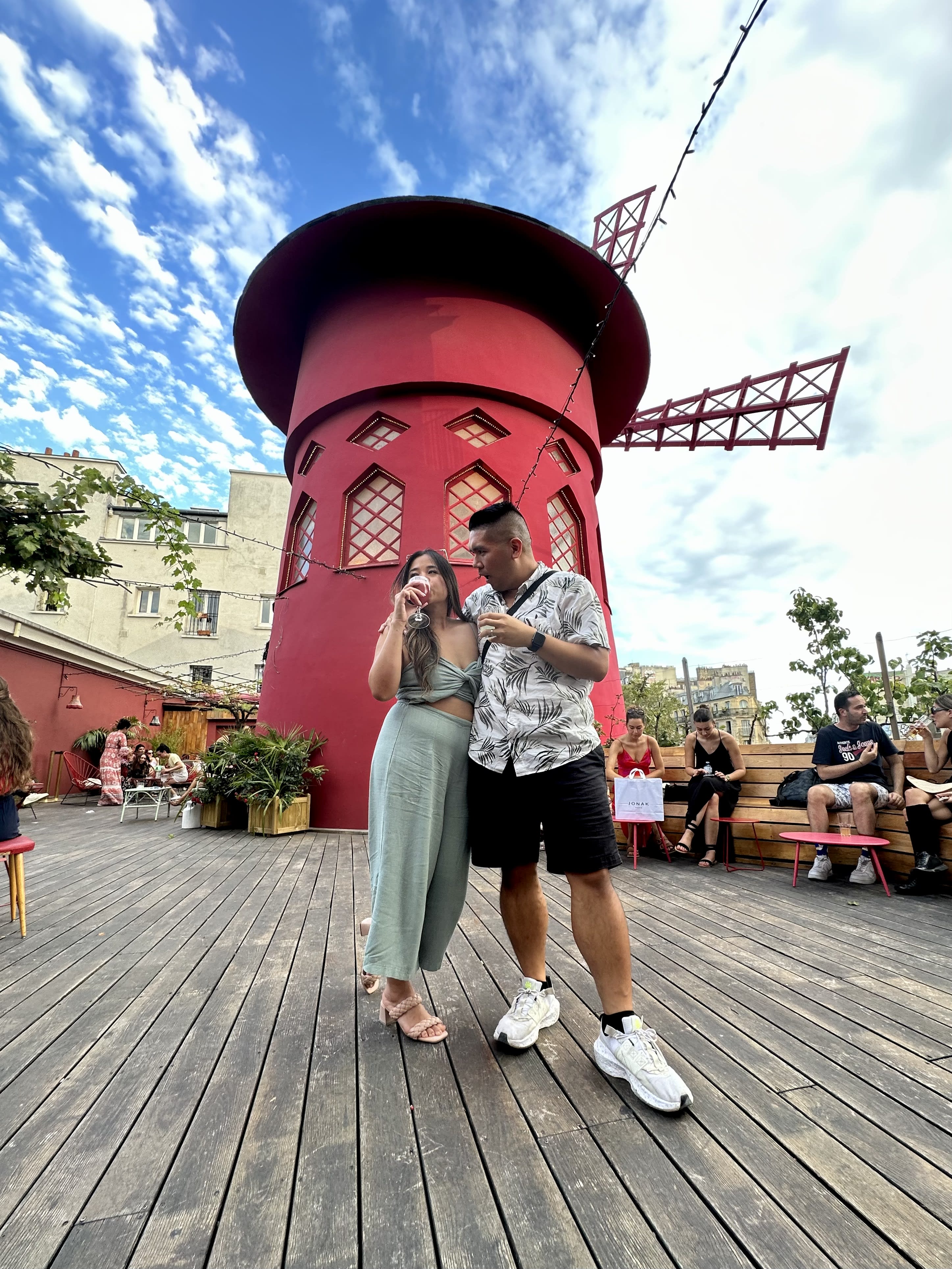 Posing for a couple photo by the red windmill