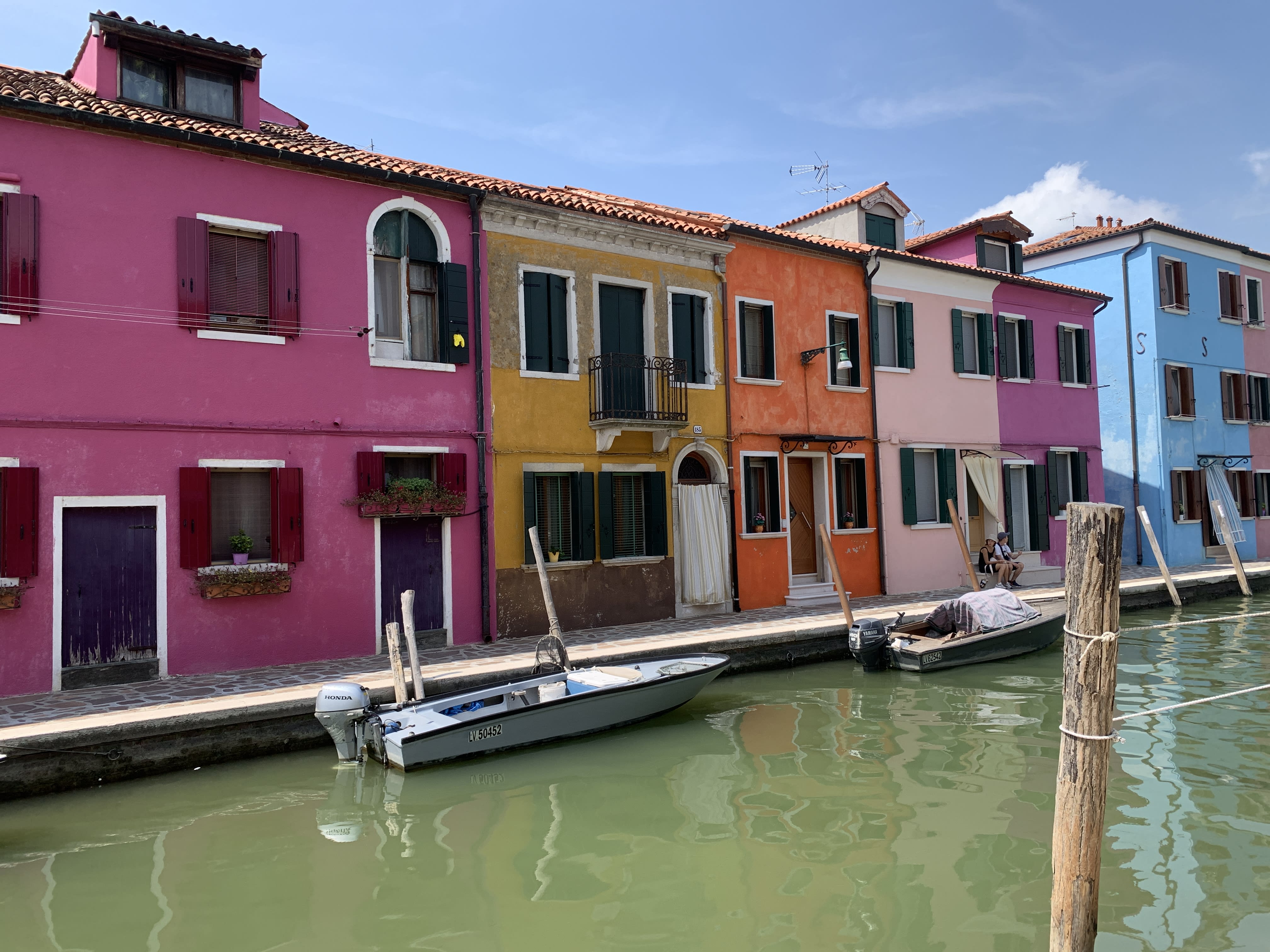 A photo of colorful row houses lining a canal