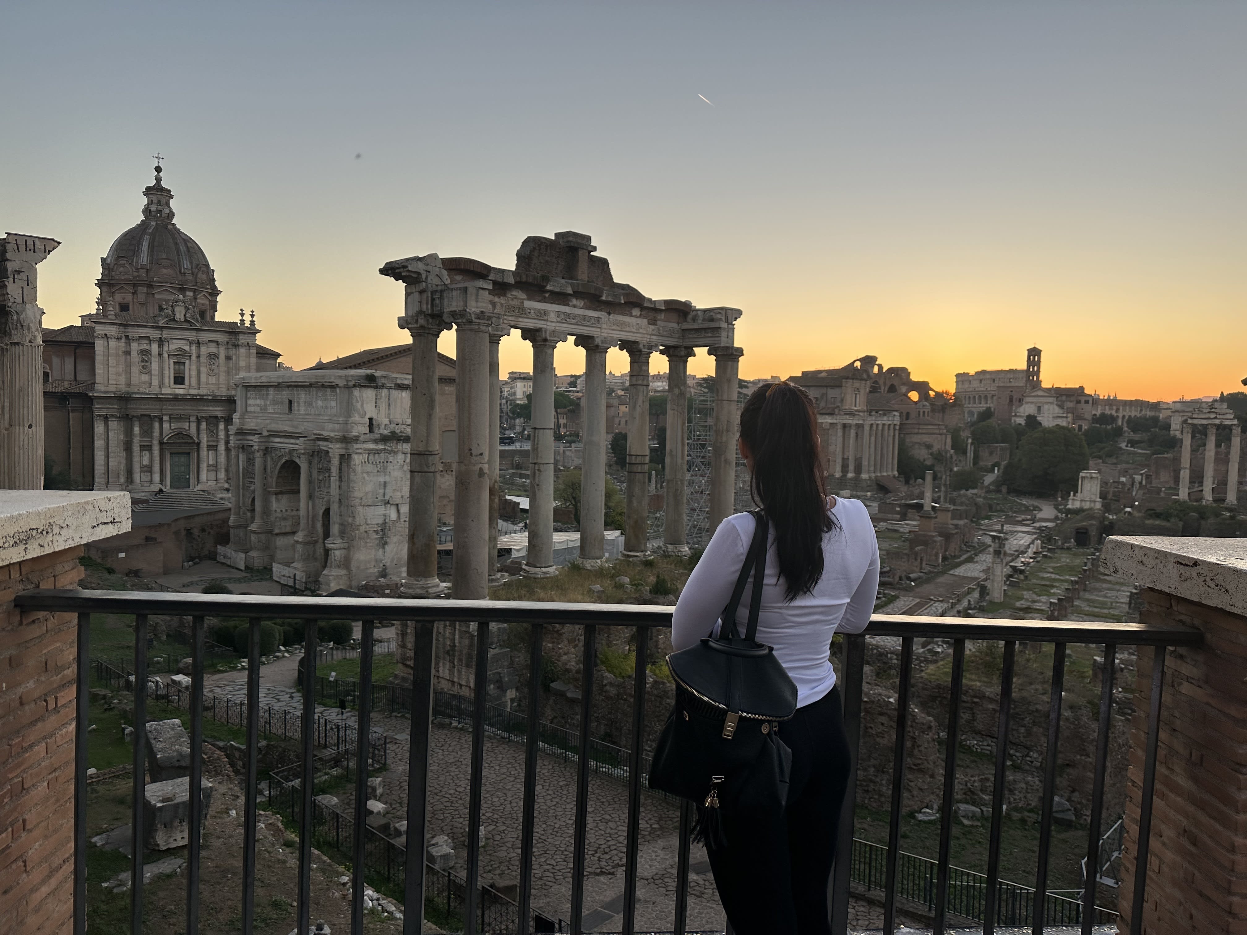 Olga on a balcony overlooking the ruins at the Roman Forum Museum at sunset