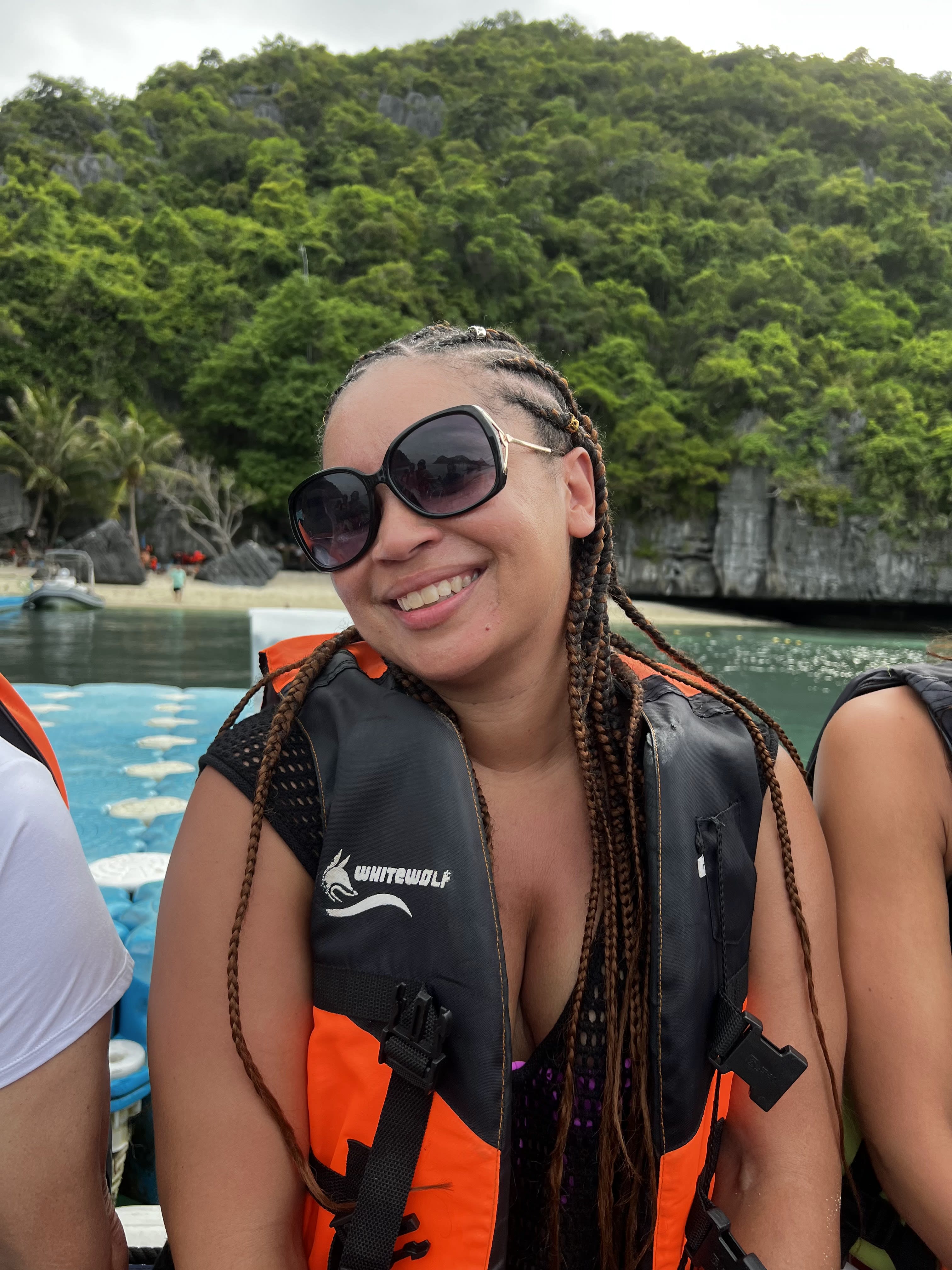 Wearing a life jacket and sitting on a boat