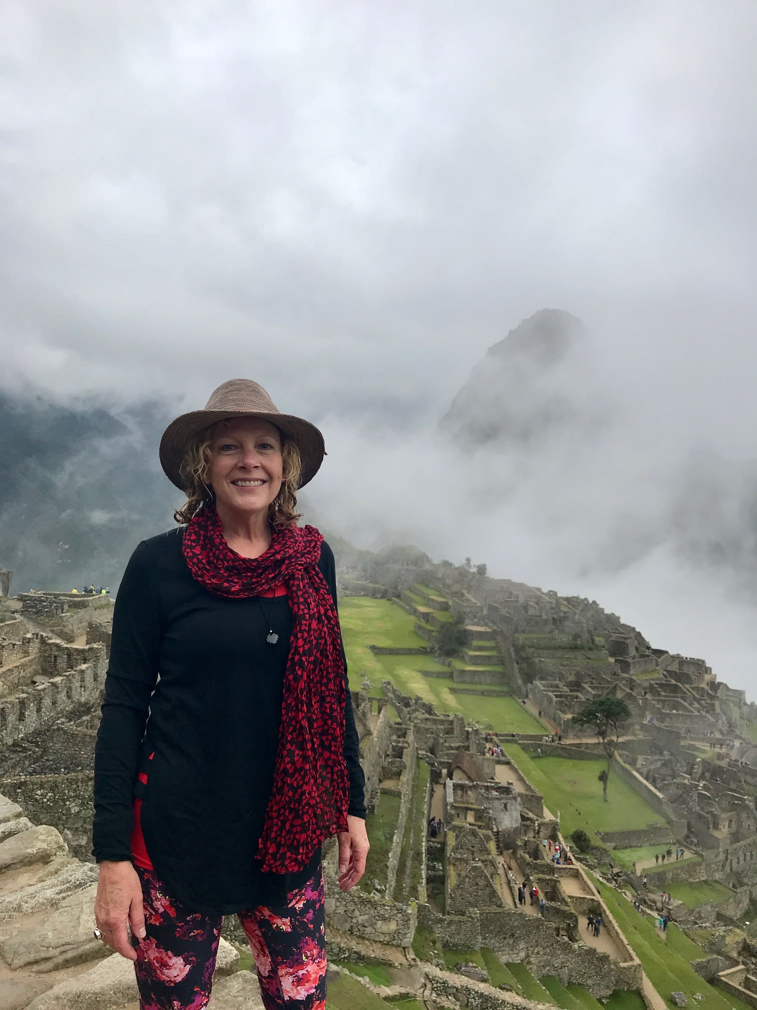 Picture of Melody wearing a hat at Machu Picchu on a cloudy day