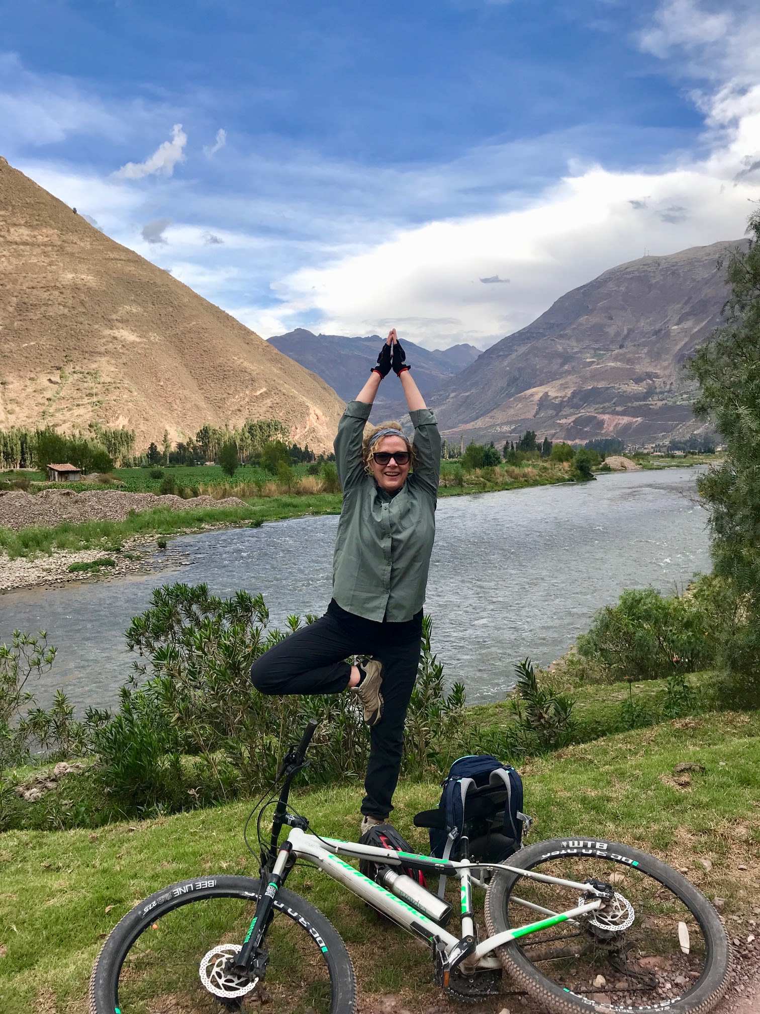 Picture of Melody in a Yoga position with beautiful river and mountains in the background