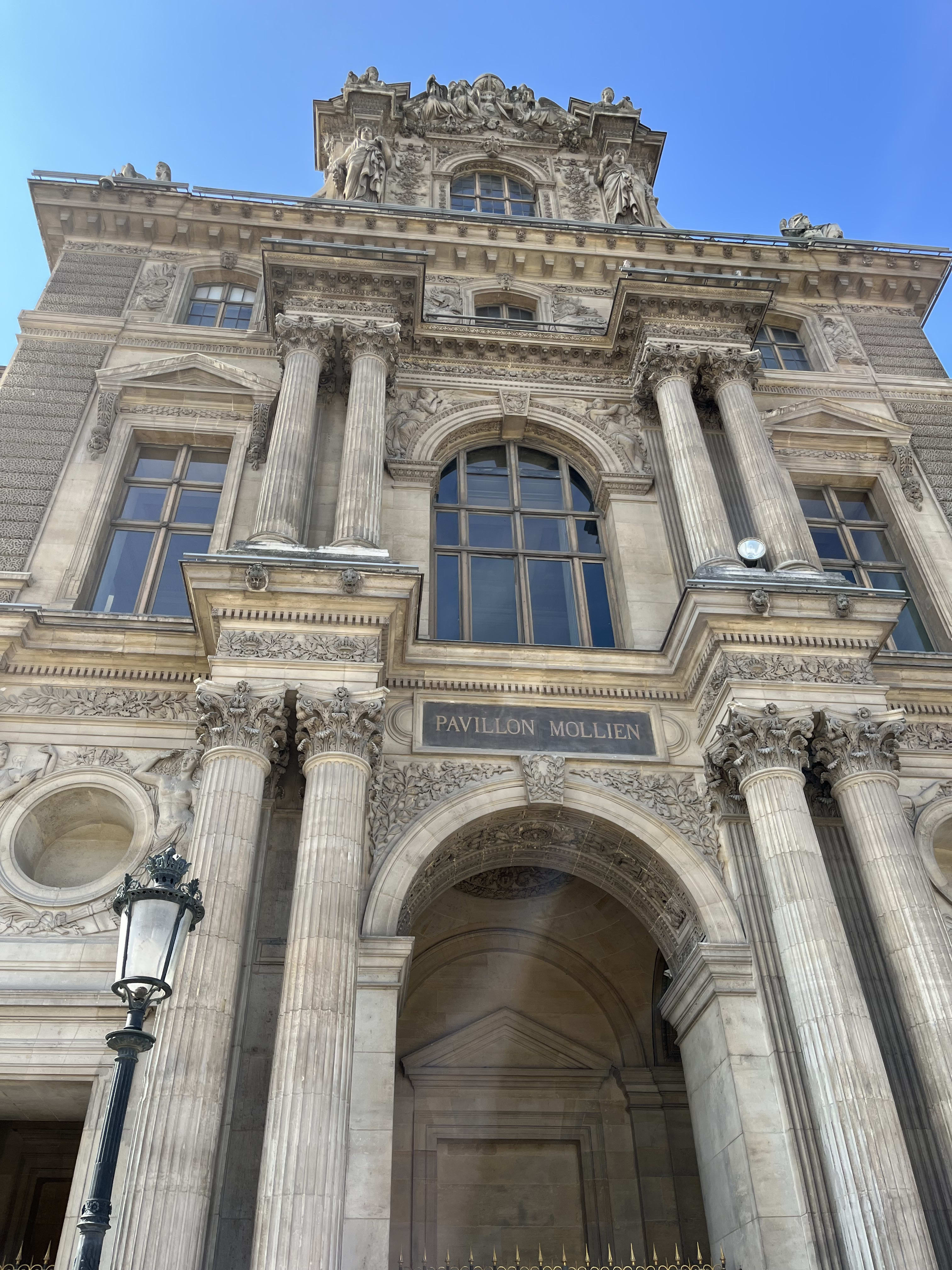 Beautiful view of a building facade at the Louvre Museum on a clear day