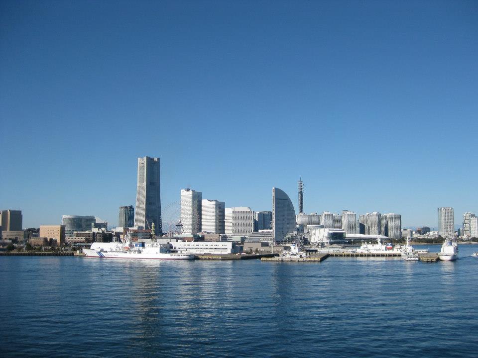 View of a modern city skyline along the water on a clear day