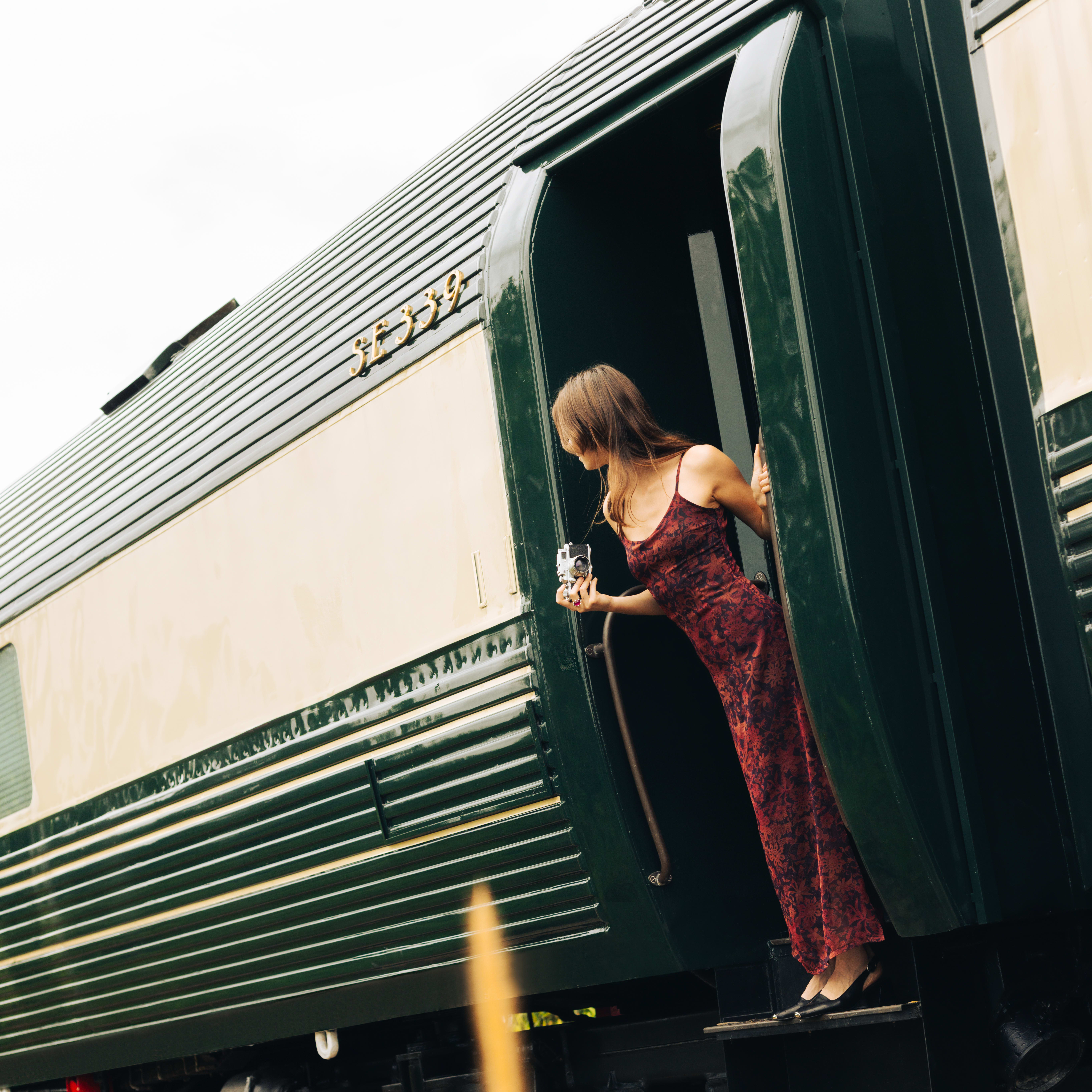Image a massage table in a luxury train carriage covered in green and white patterned sheets 