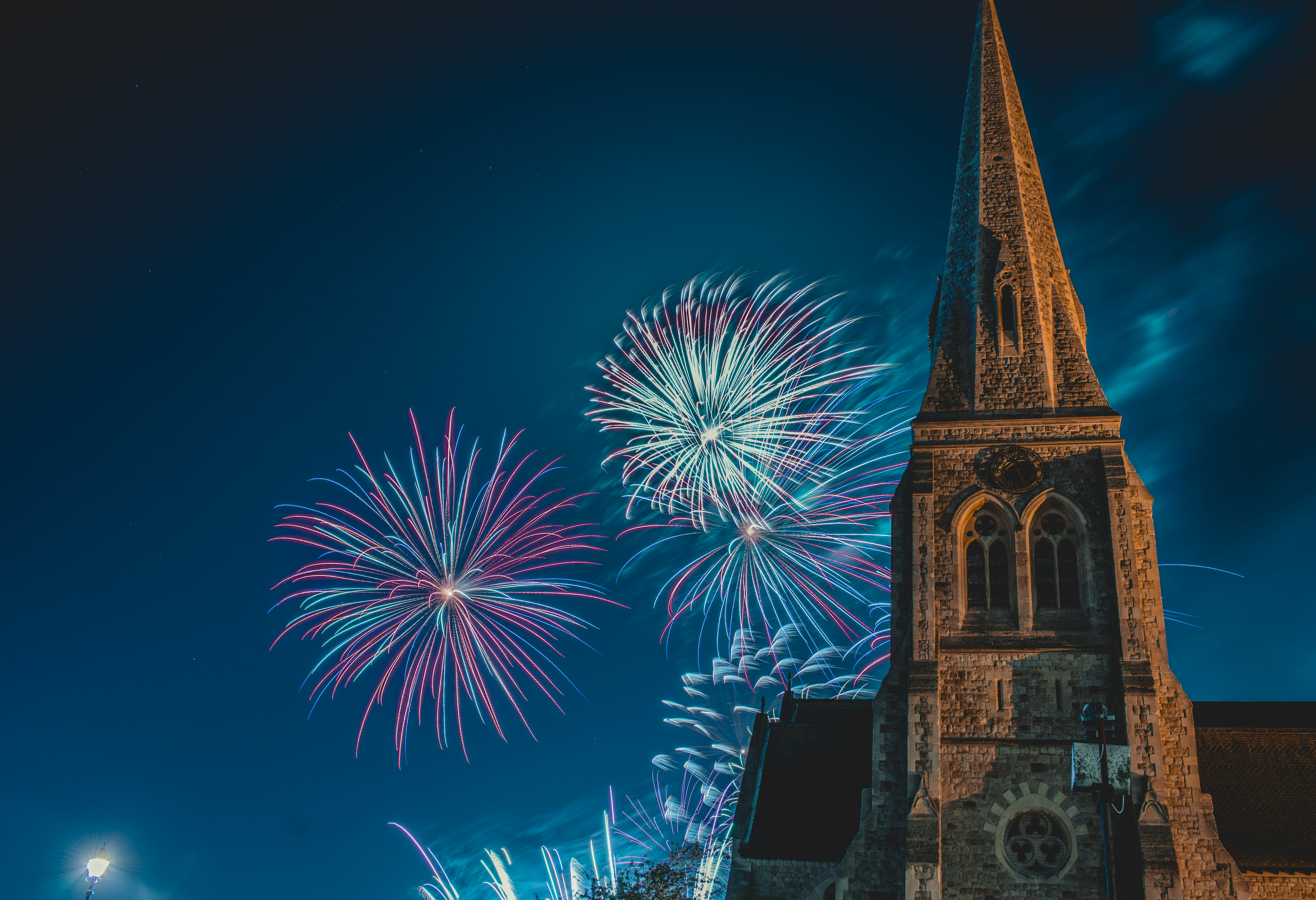 night sky with fireworks and a steeple
