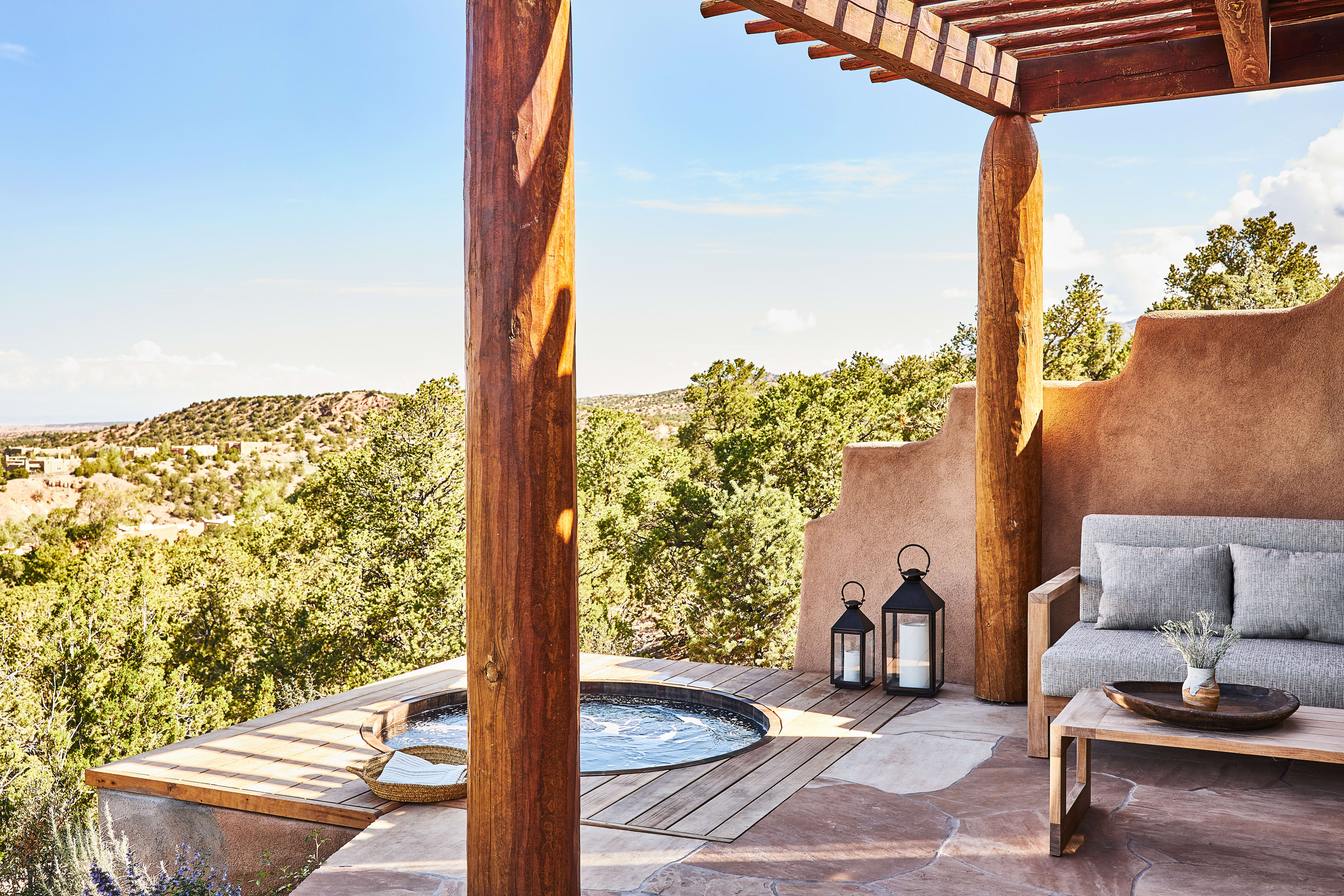 a wooden outdoor deck with a small pool overlooking the desert
