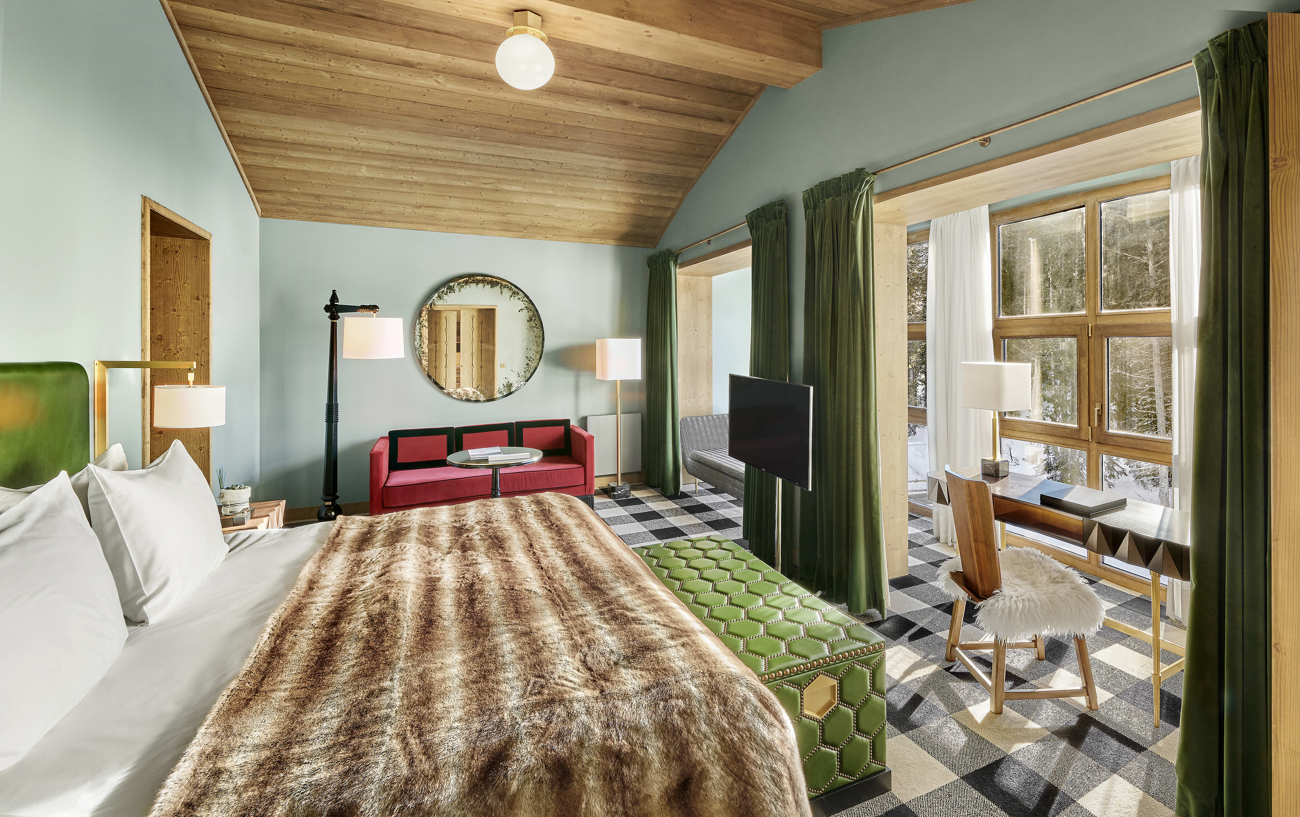 a luxe hotel room with a bed covered by a furry blanket