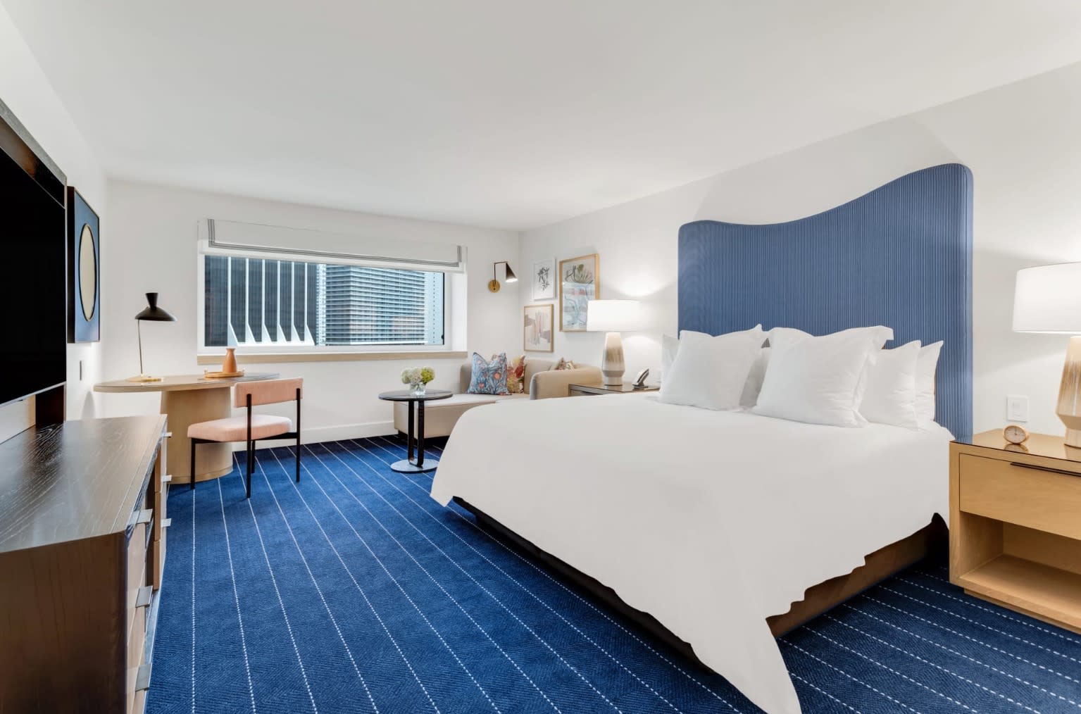 blue and white guest room with large white bed