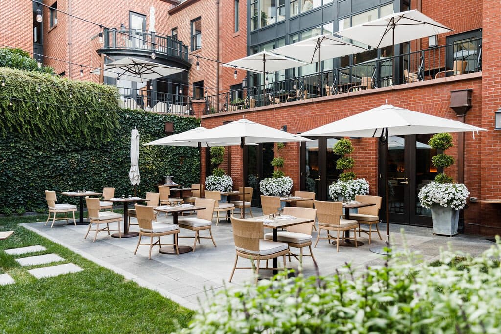 a sunlit courtyard amid a brick building complex