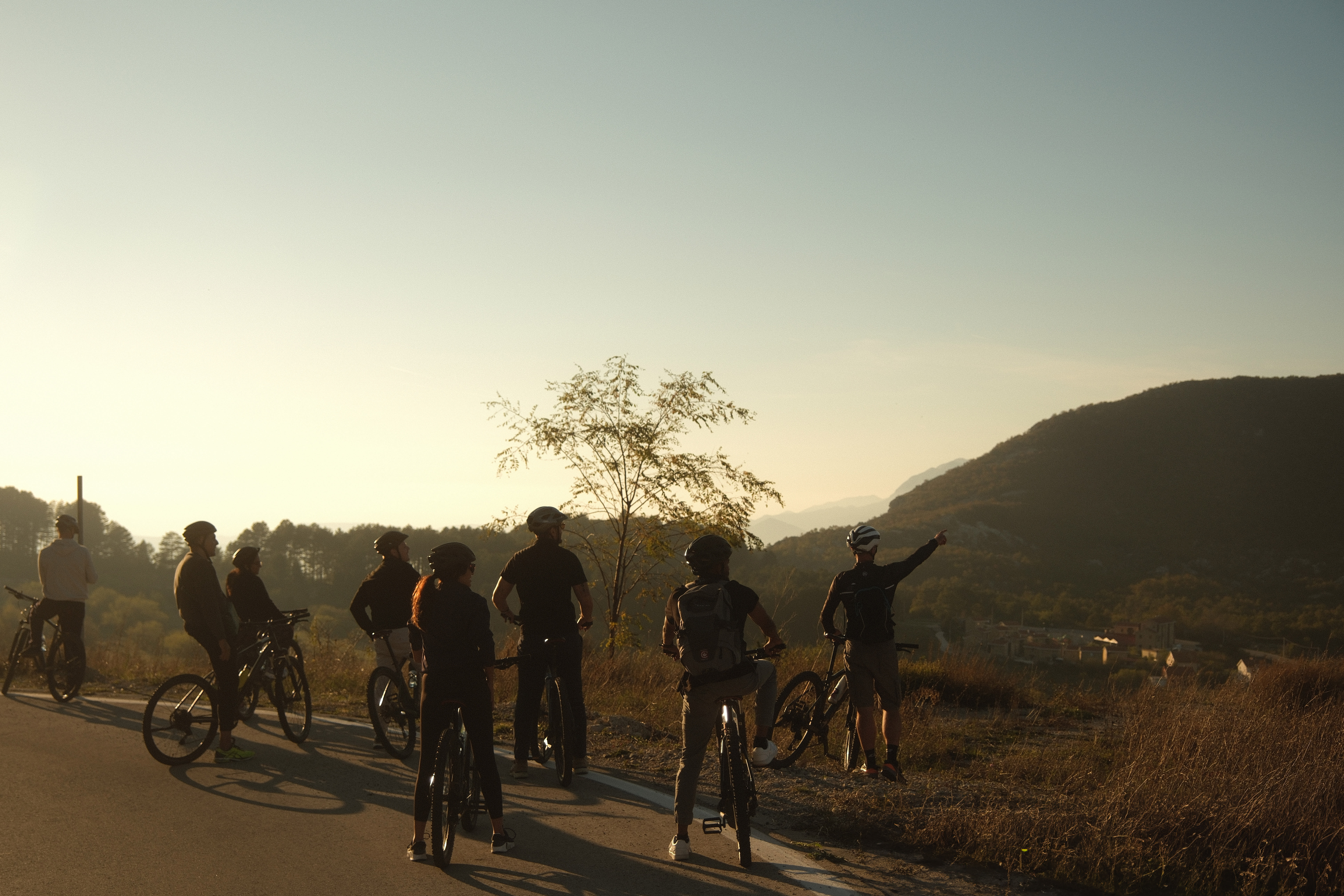 A group of people cycling with mountain views