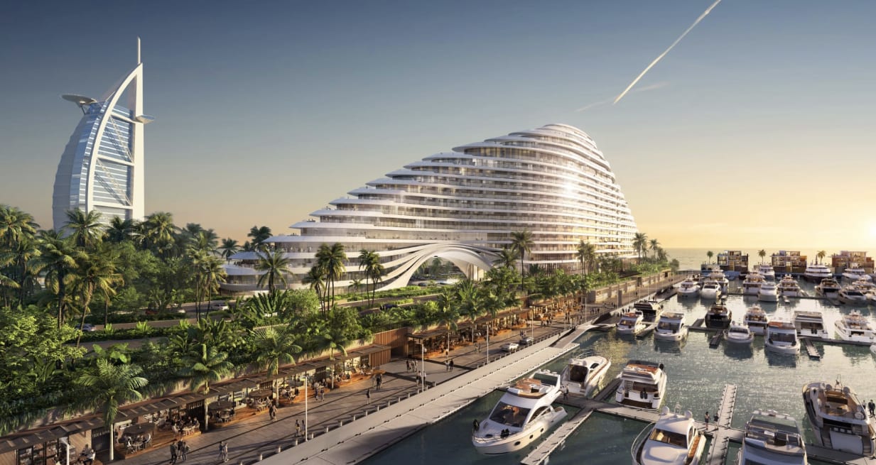 A view of a marina with boats docked in front of a large modern building in the shape of a ship