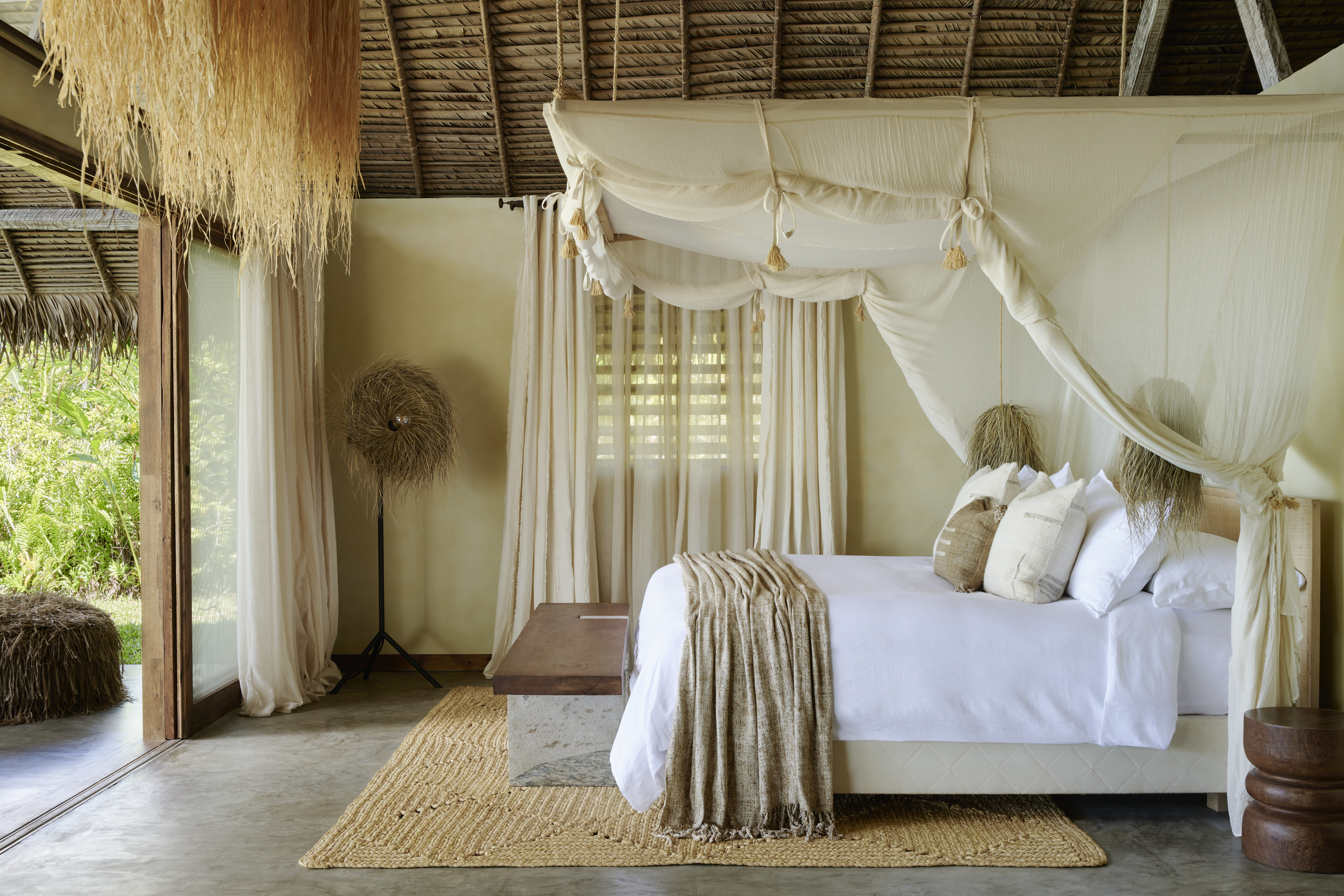 a canopy bed in a fancy bedroom in the jungle