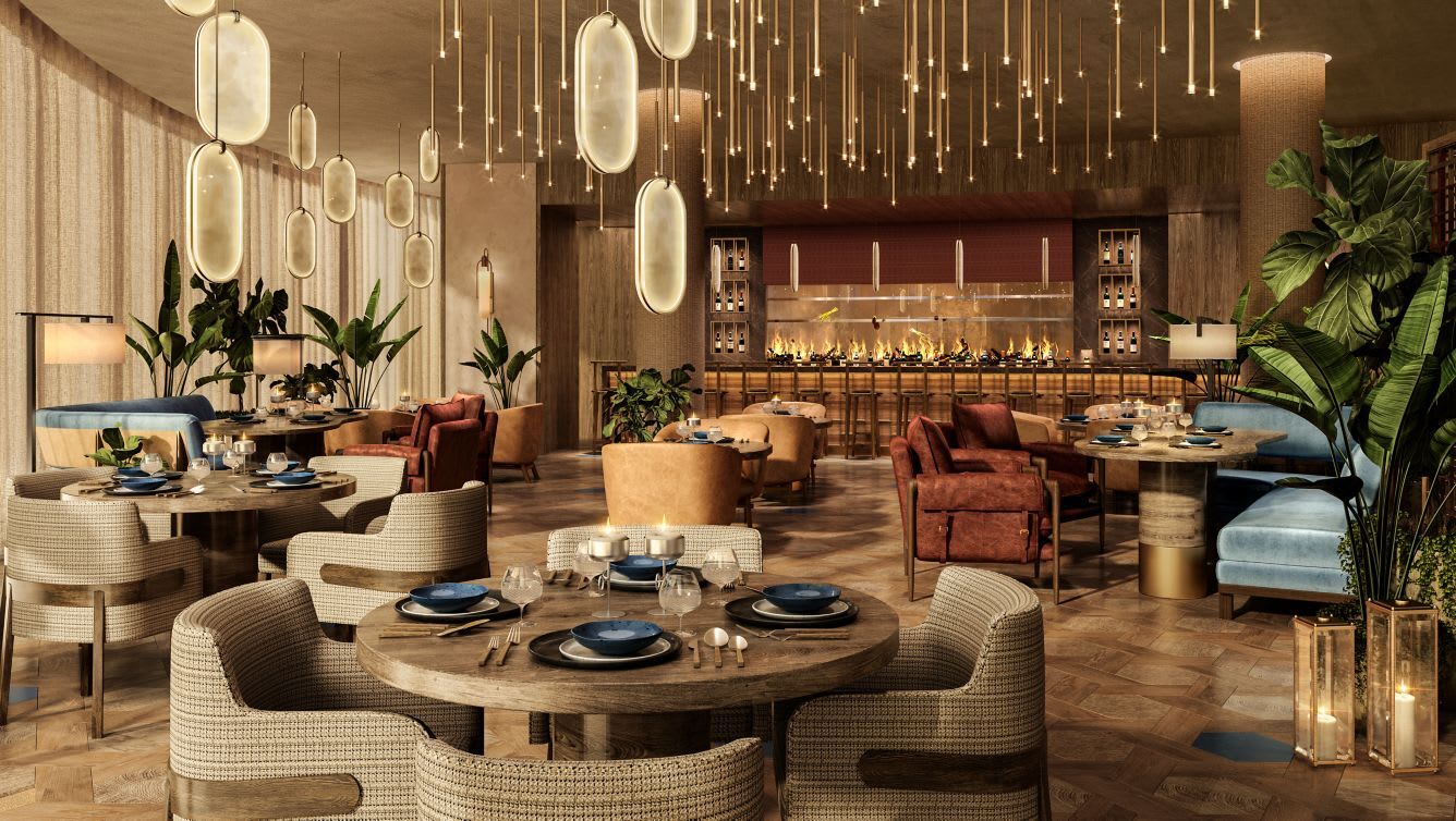 A hotel restaurant with brown and cream tones and hanging lights