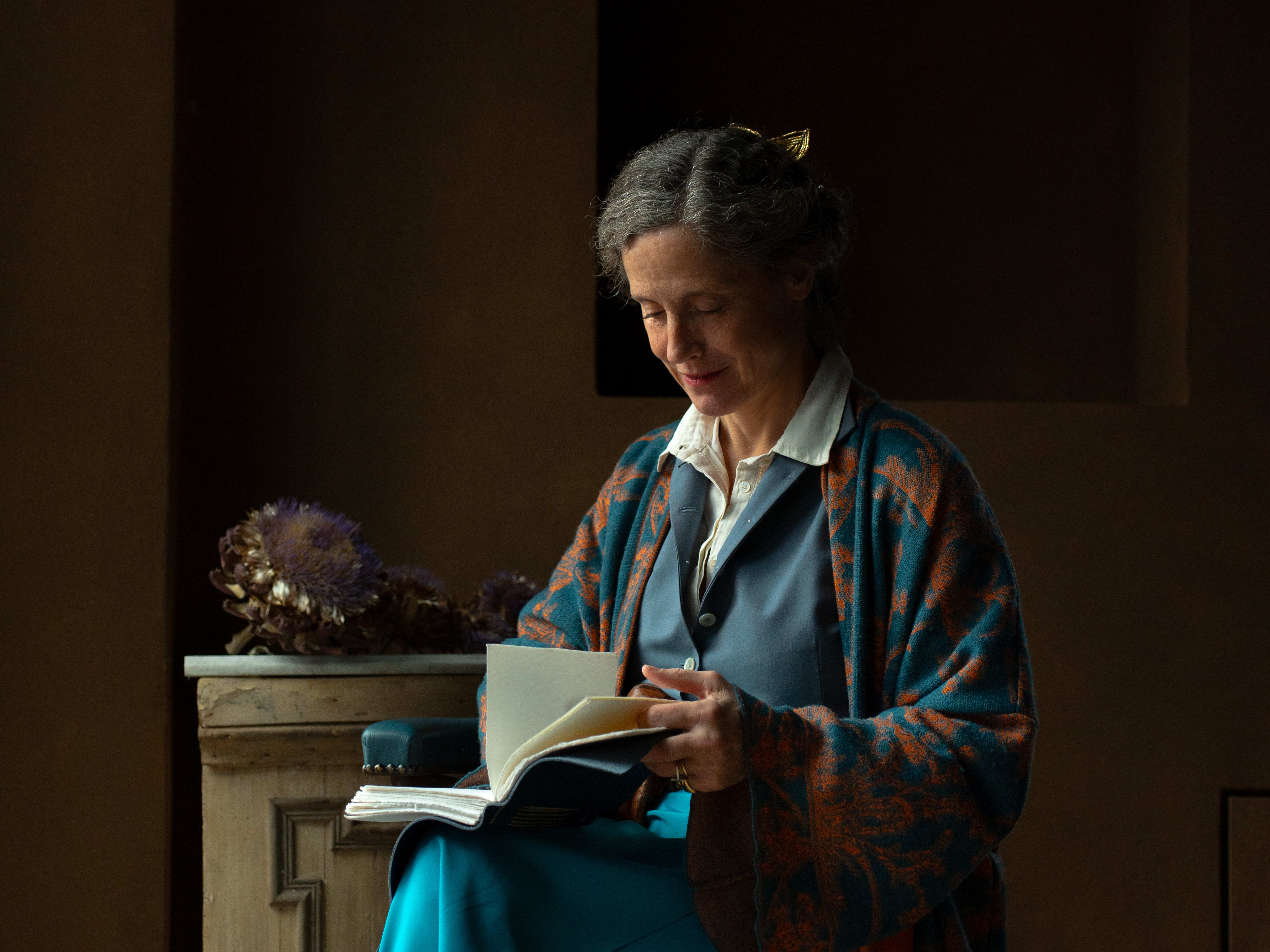 woman sitting in a chair reading