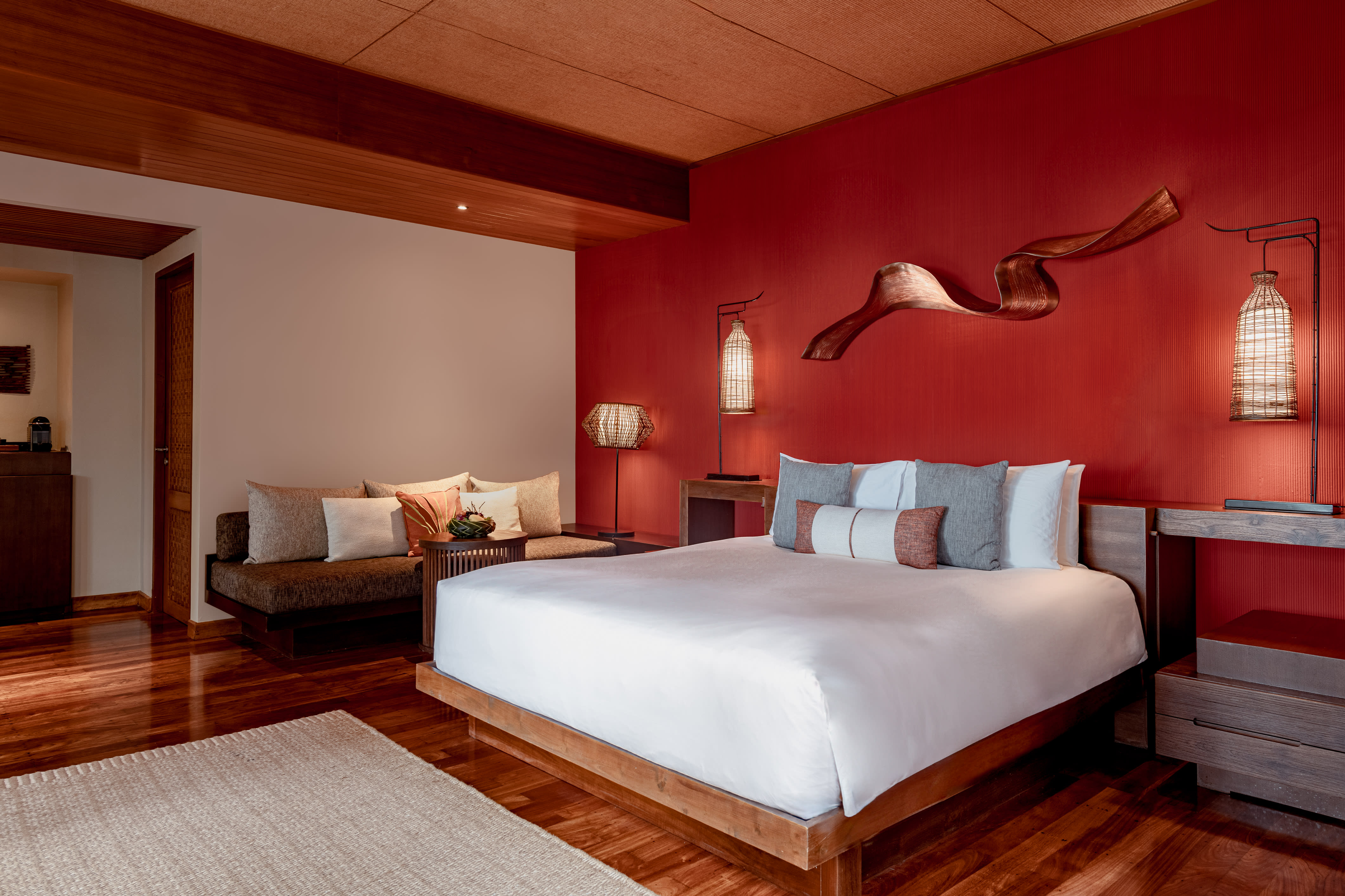 a fancy hotel bedroom with red walls