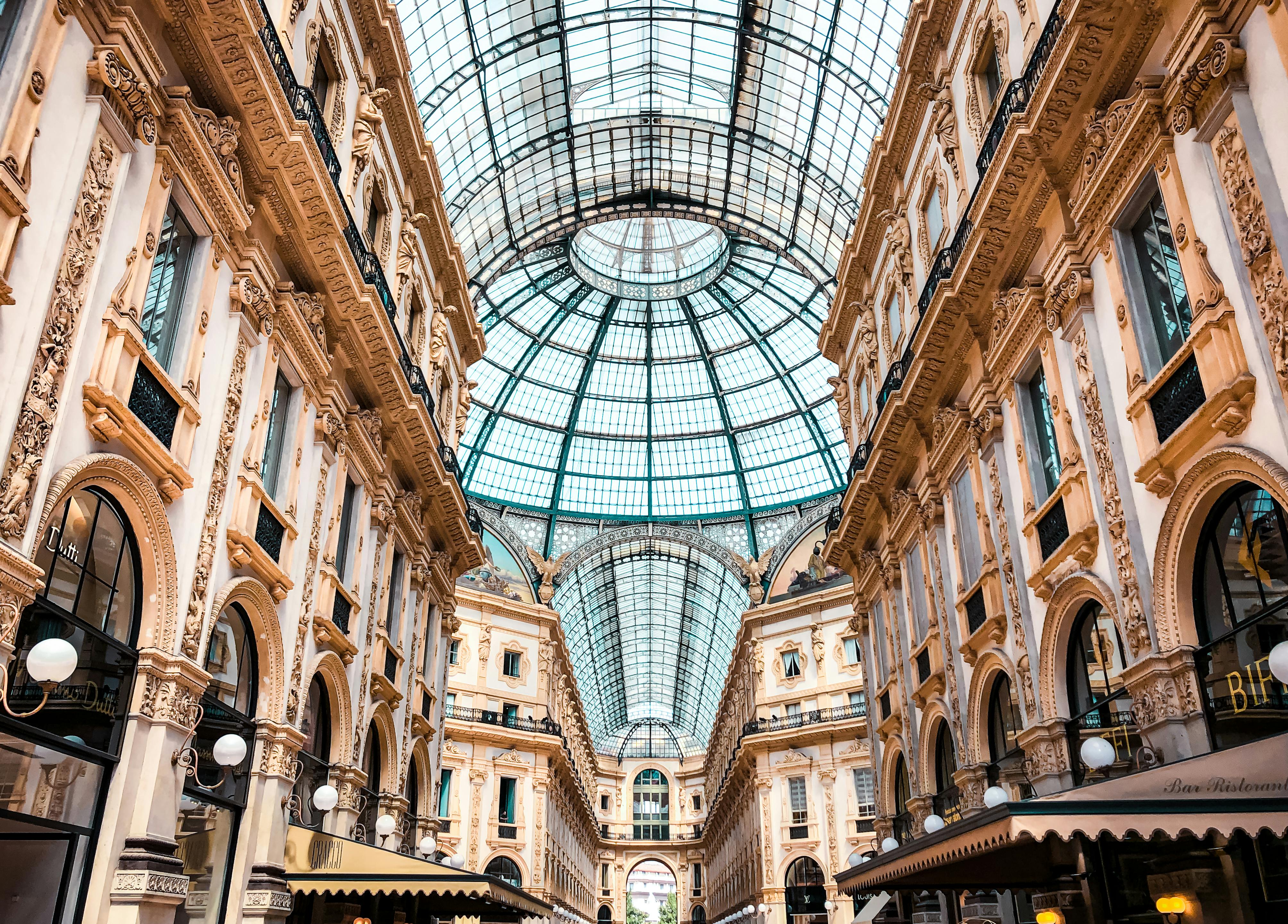 ornate shopping arcade with a domed glass ceiling