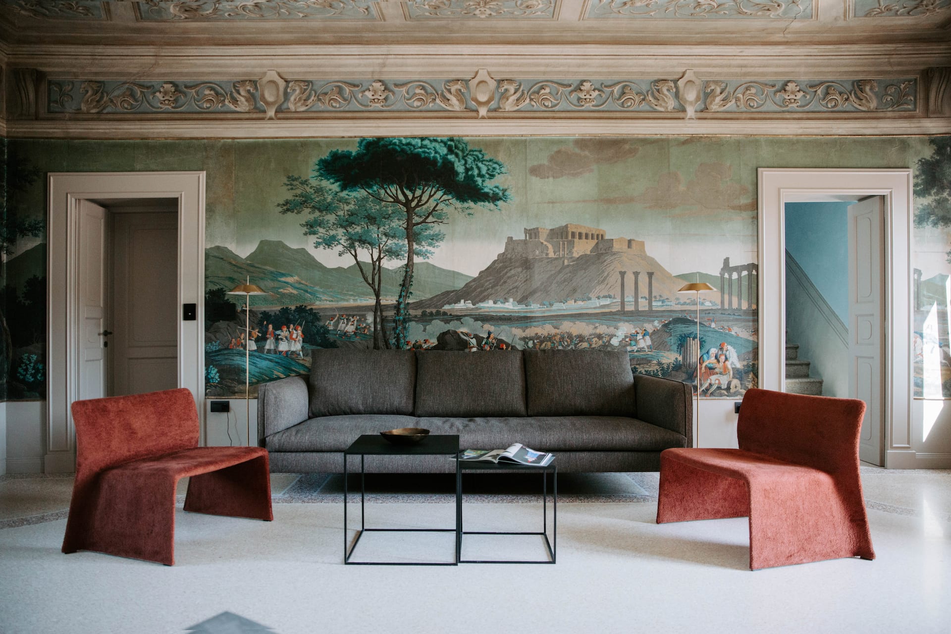 A hotel lounge with antique and modern asthetic with artwork on the wall