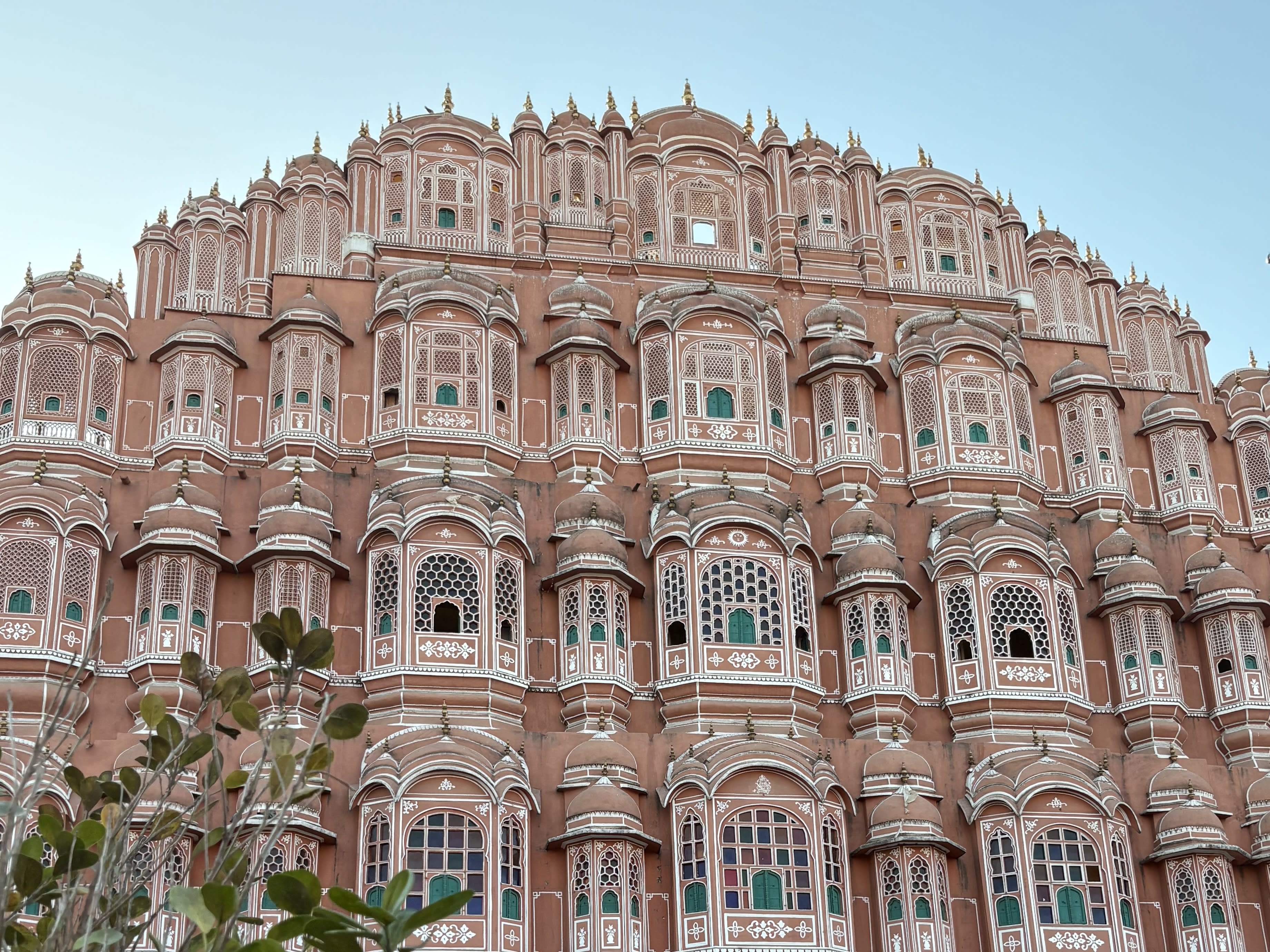 an elaborate pink building with small windows