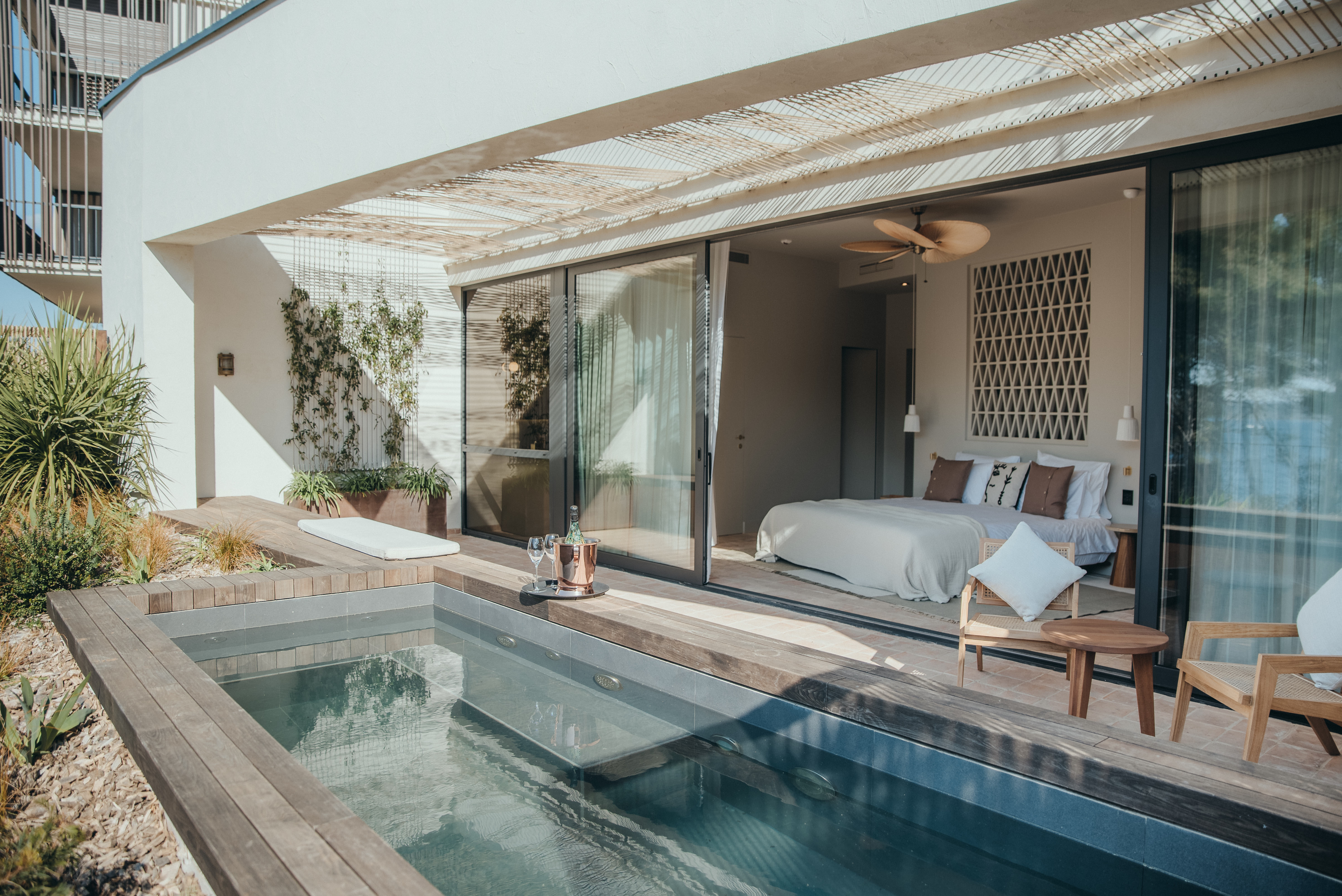 A hotel room with a private pool on the terrace