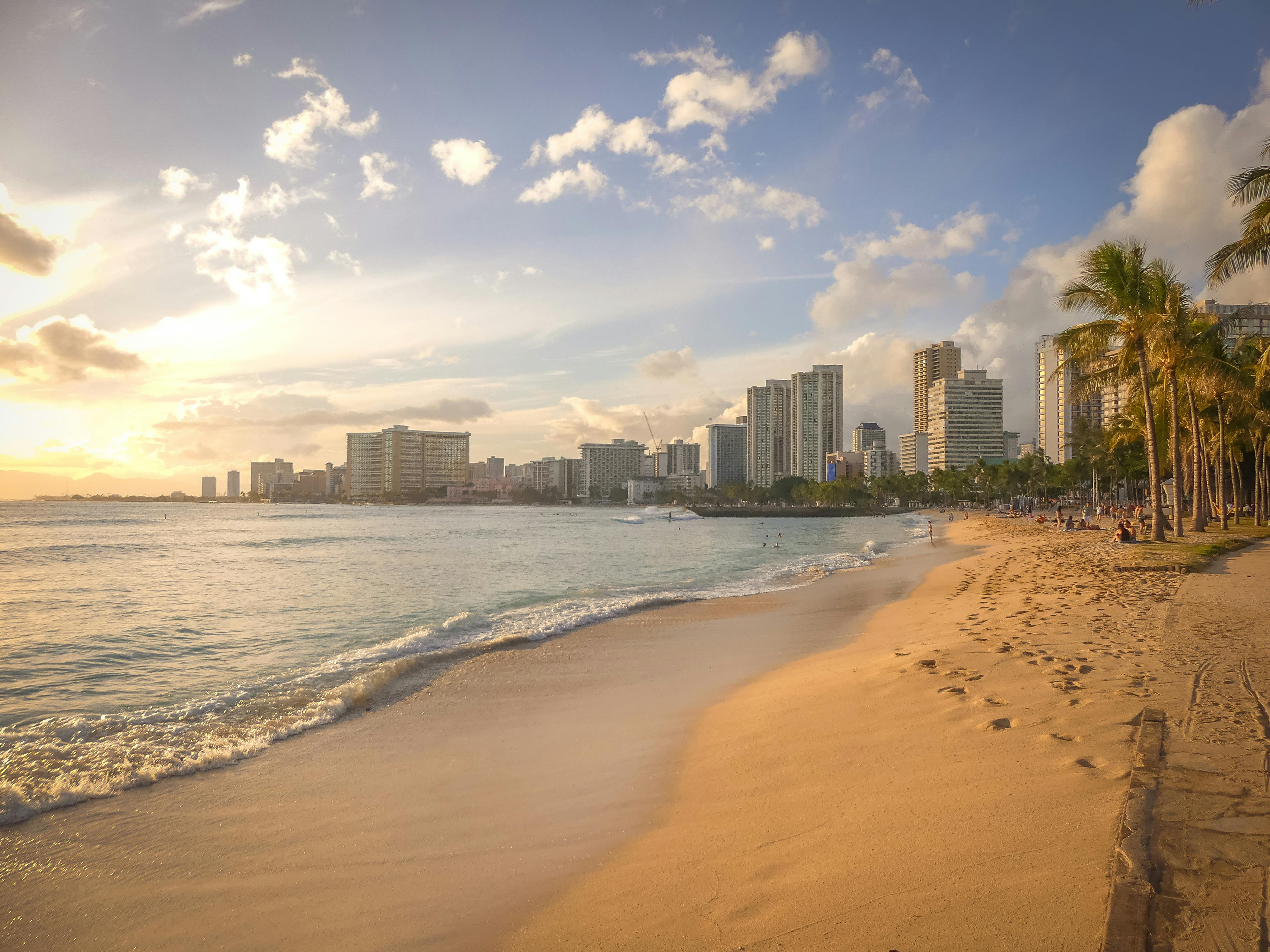 Highrise buildings along the tropical beach with the rising sun just off camera