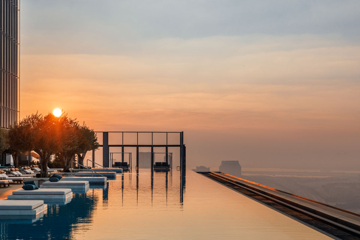 an infinity pool at the top of a building overlooking a city