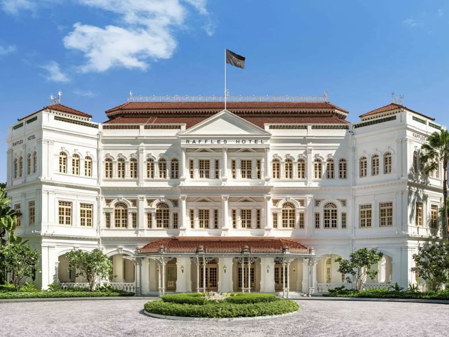 A colonial style white walled and brown roofed building