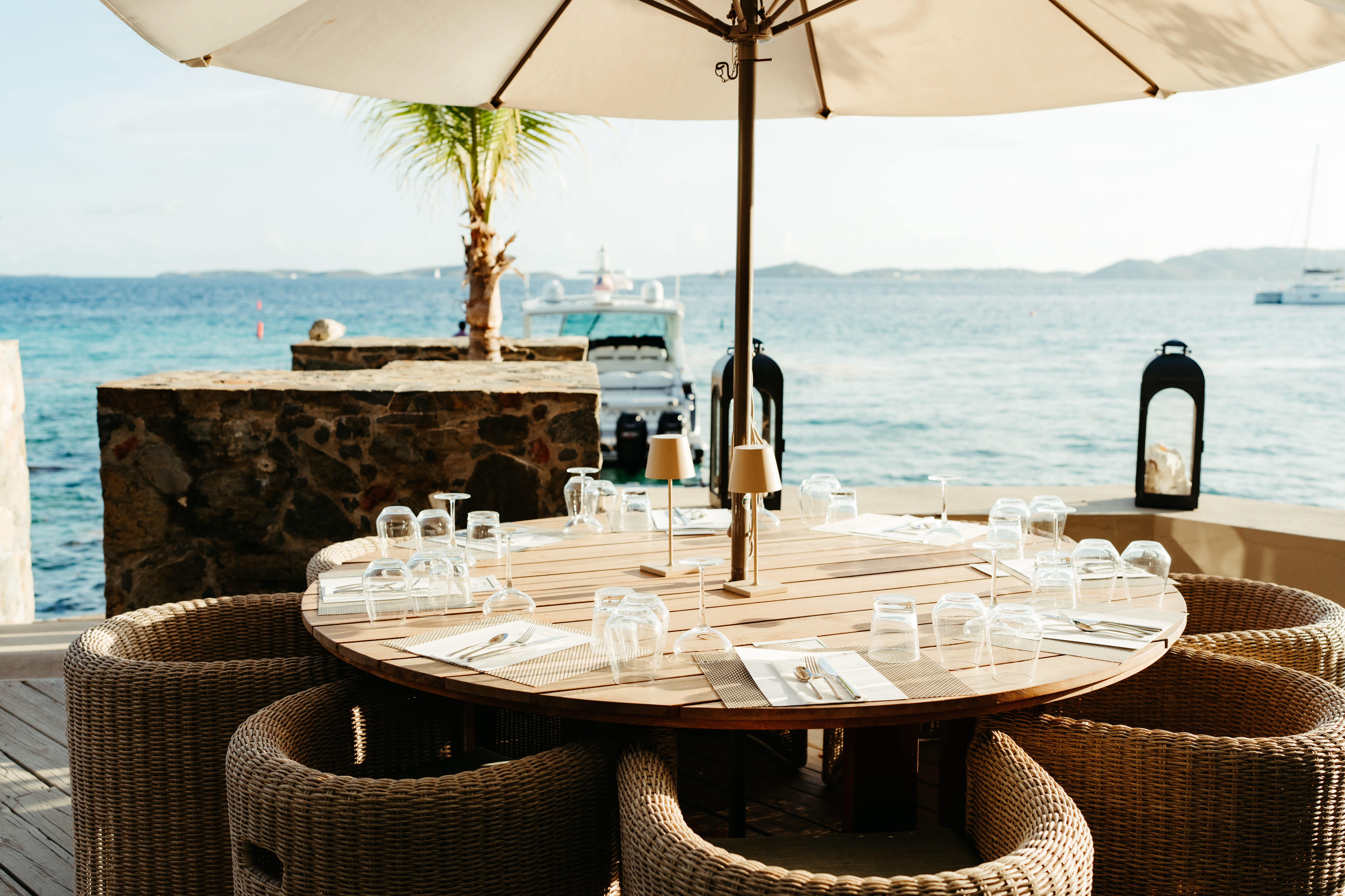 a round wooden dining table overlooking the sea
