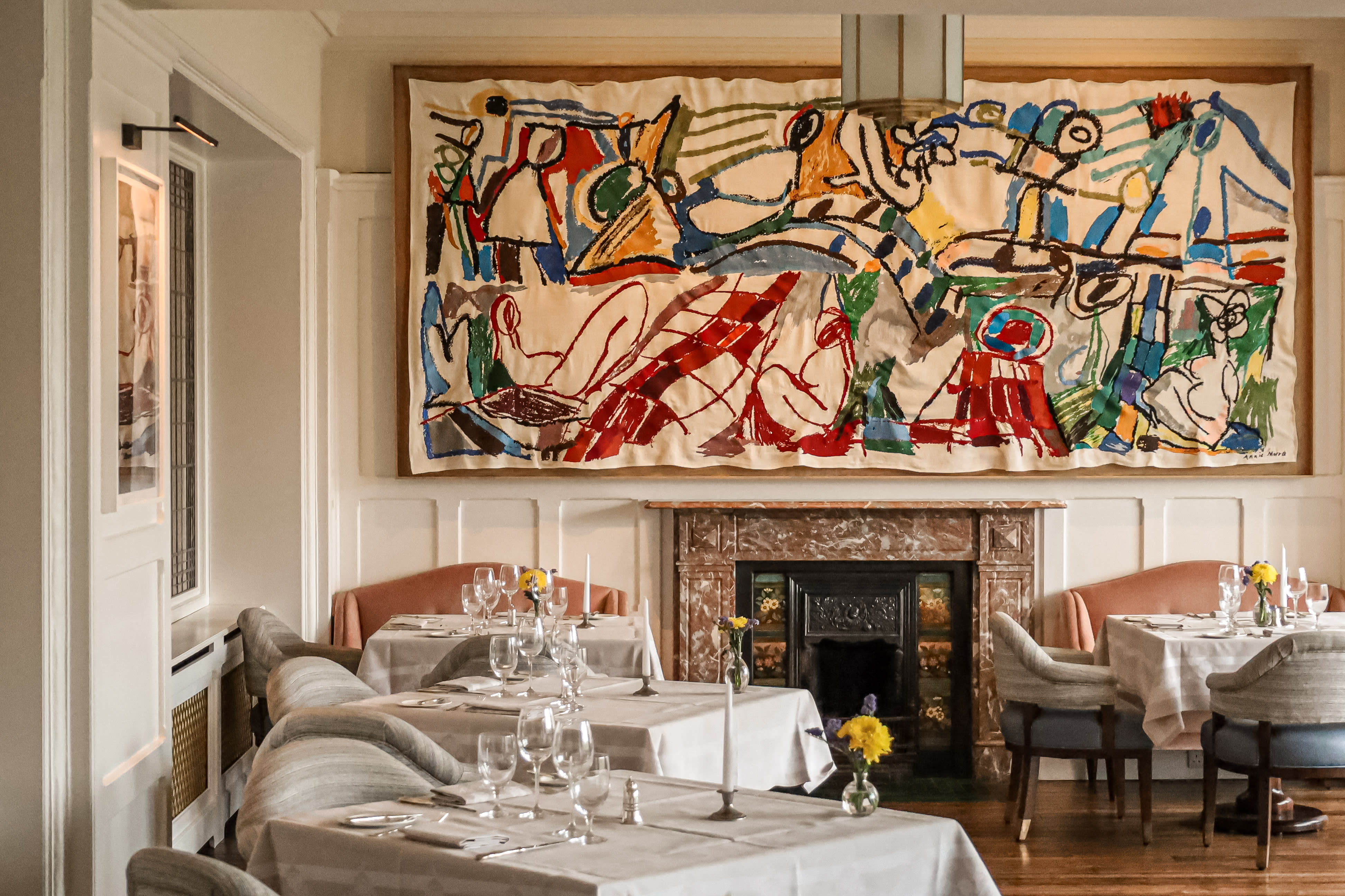 a colorful modern painting in an elegant dining room