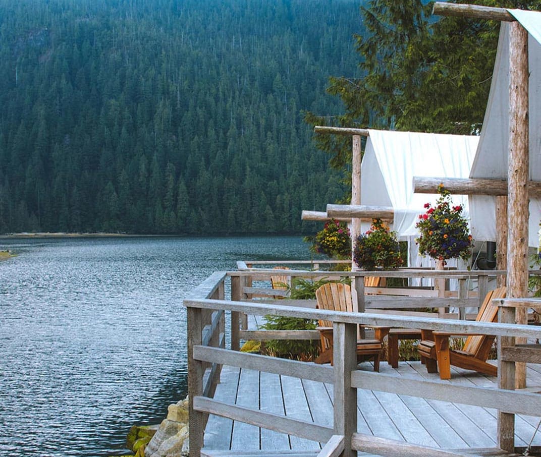 a wooden deck overlooking an alpine lake
