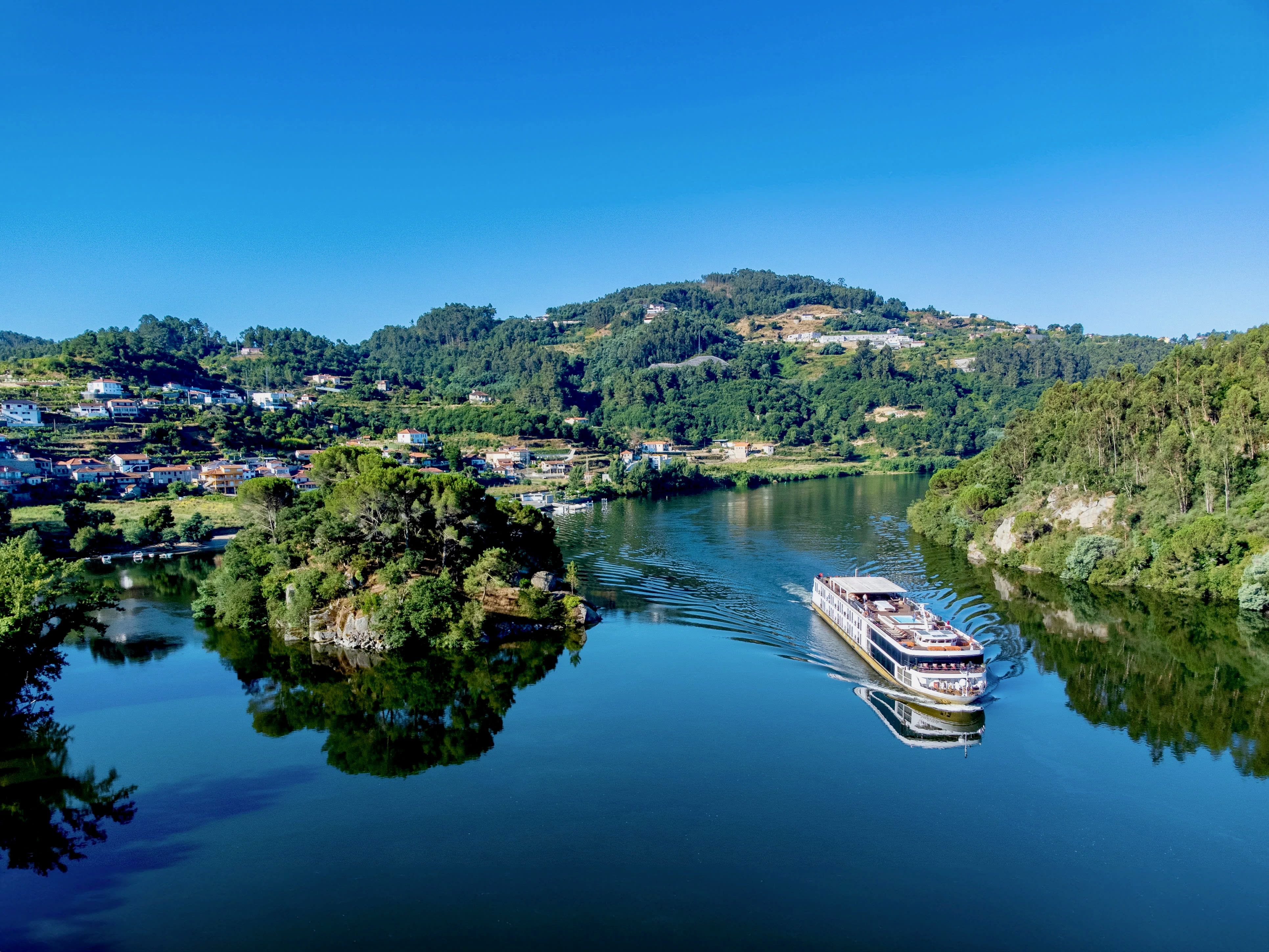 A river cruise on a serene river through a valley during day