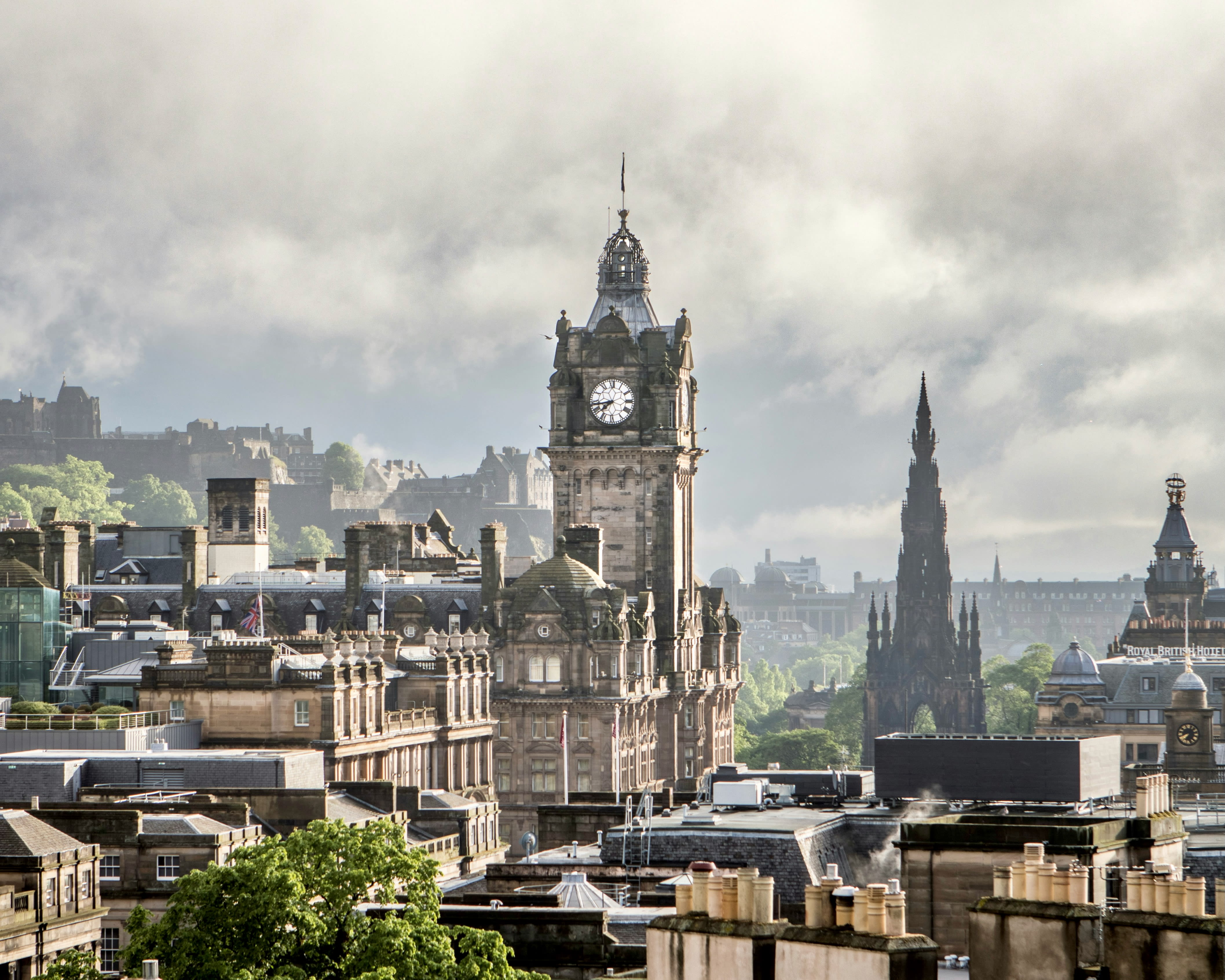 Edinburgh skyline with clock tower and cloudy skies during day
