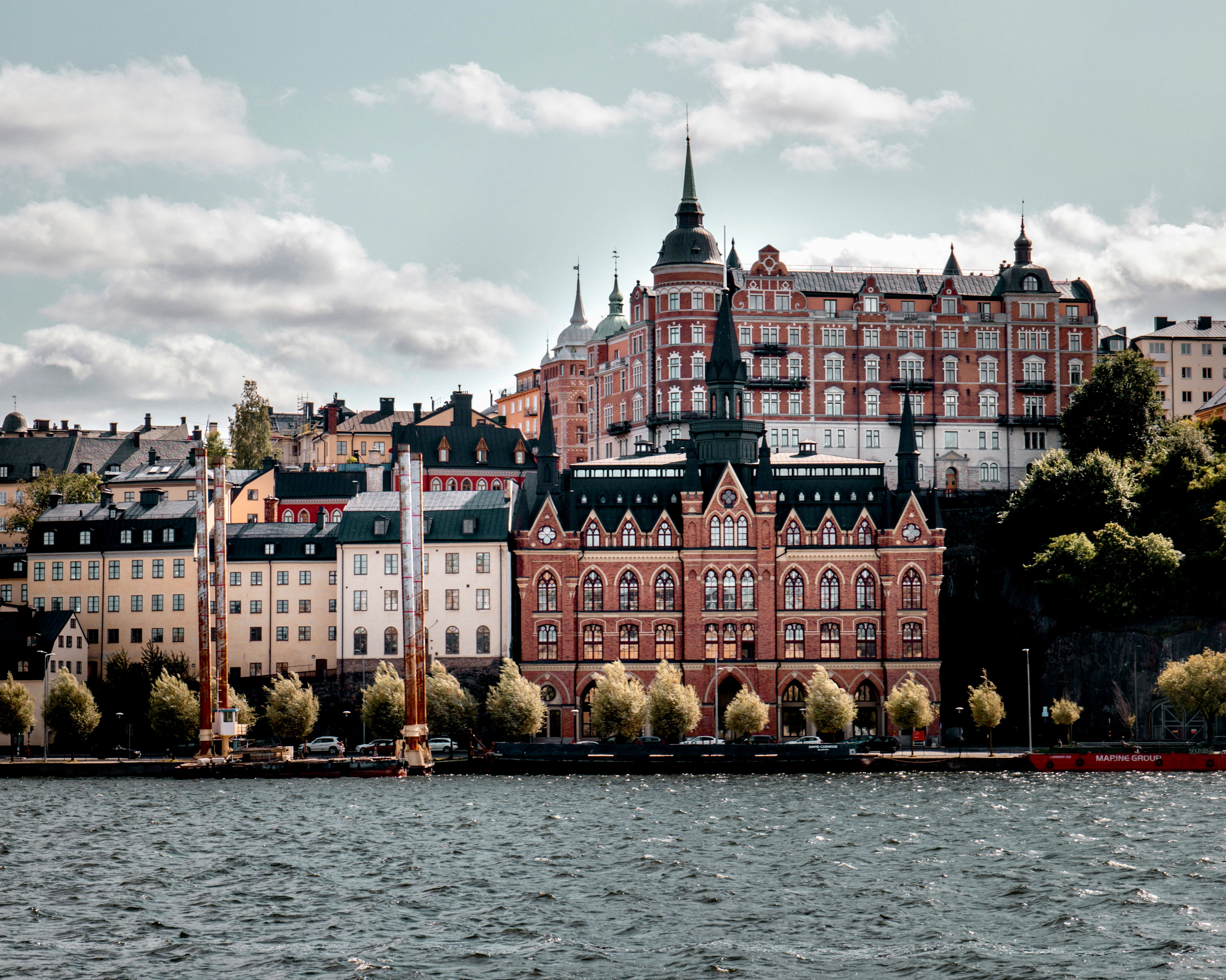 white and brown buildings on a riverfront during day