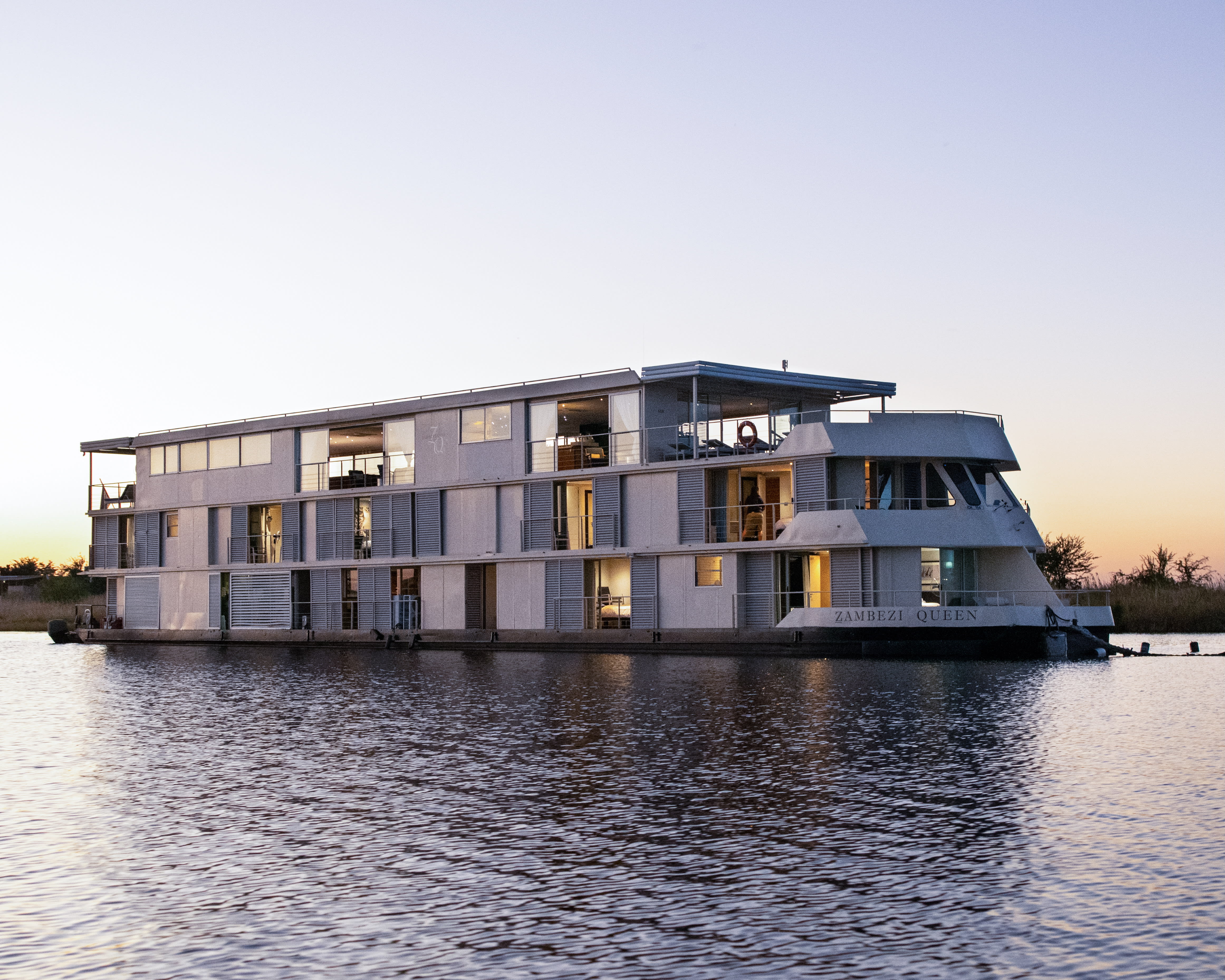 a modern river cruise boat on calm waters at dusk