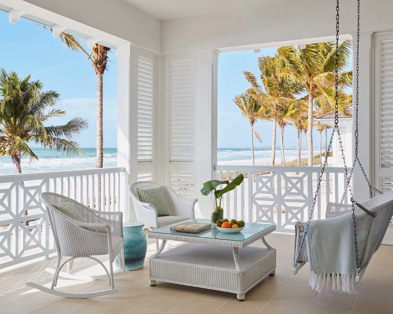 white beachfront and oceanfront porch with outdoor furniture