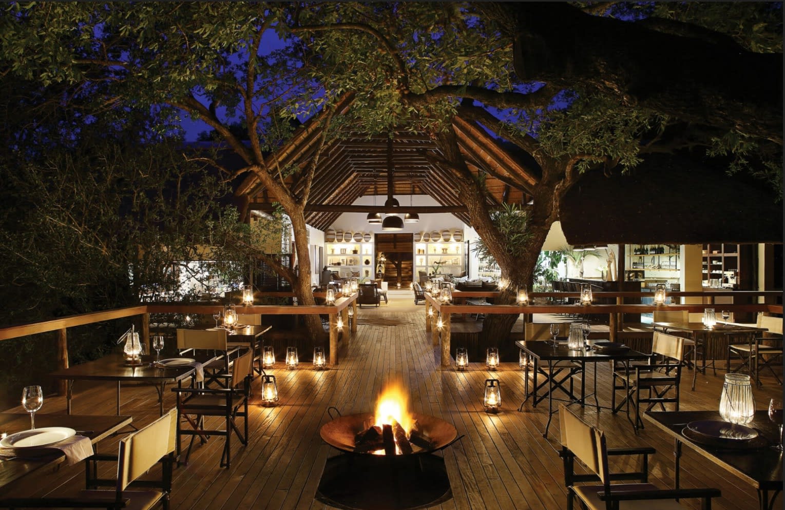 outdoor deck with lanterns and an arched gathering space behind