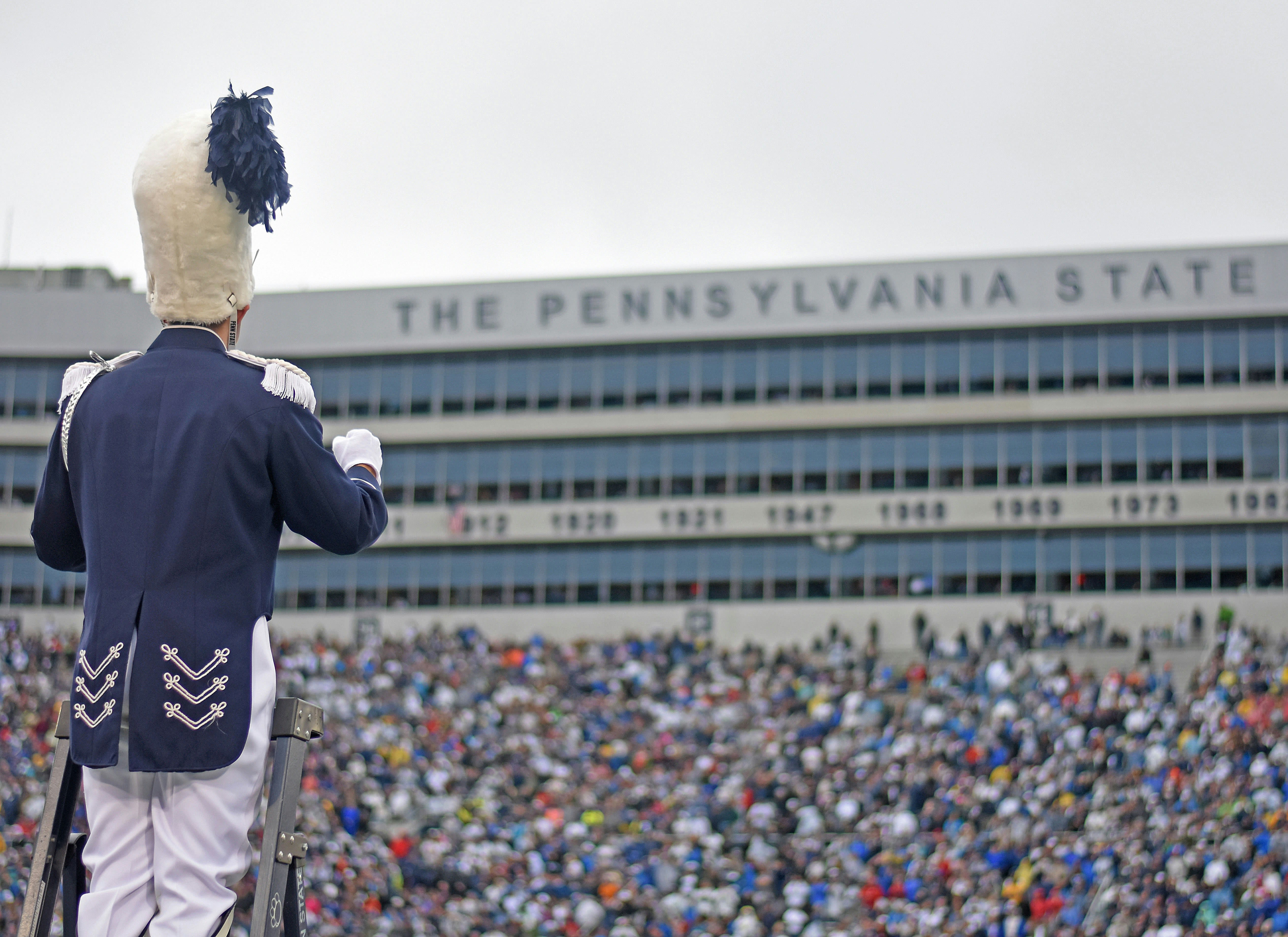 band leader standing in a crowded football stadium
