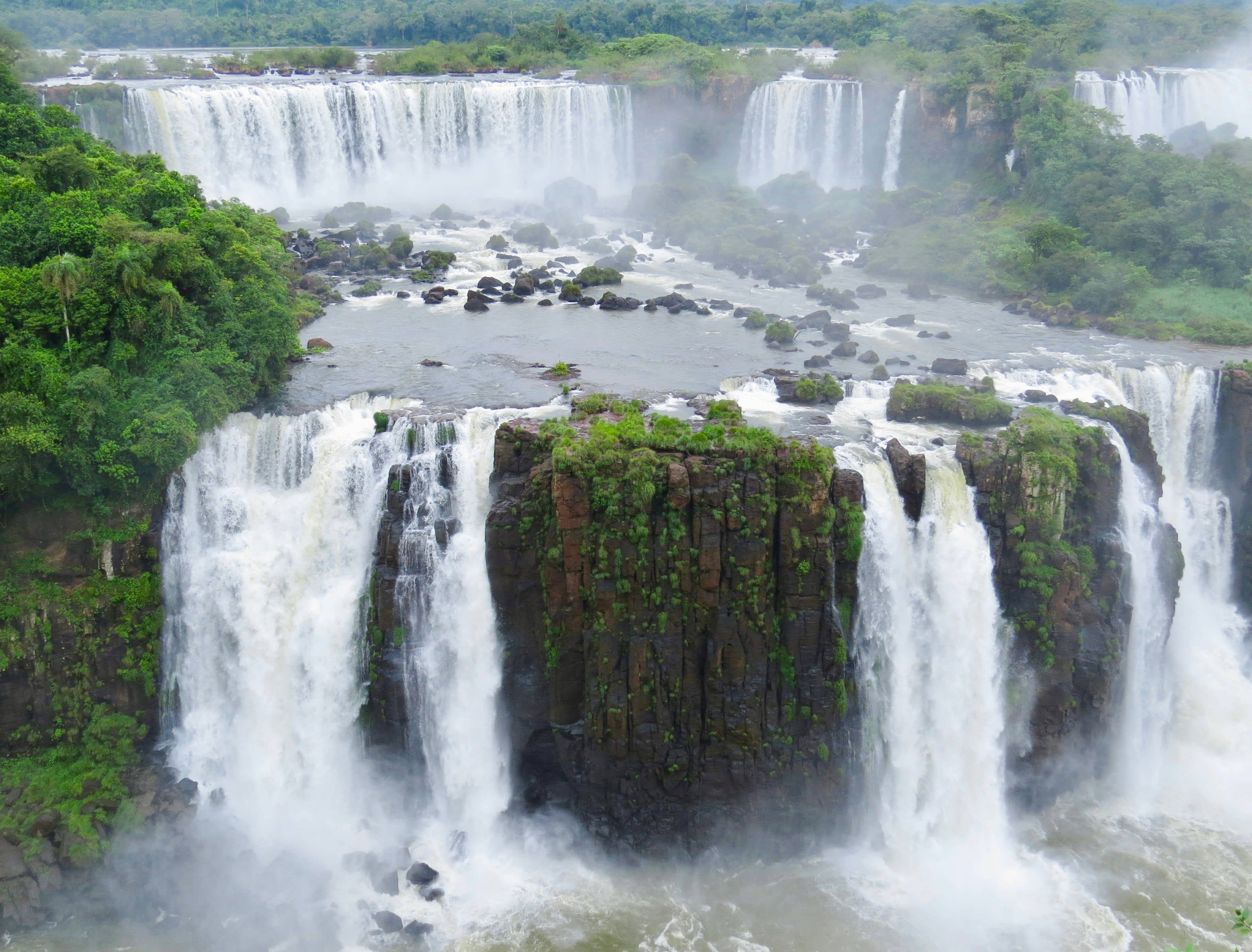 step waterfalls through a green jungle landscape