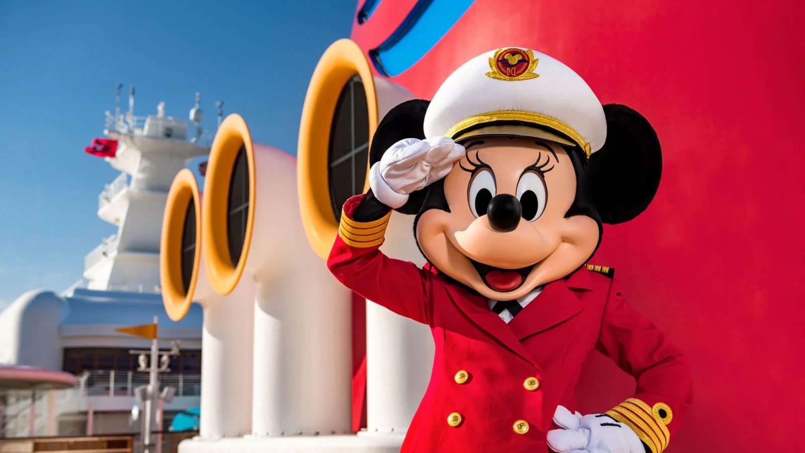 Mickey in captains hat and jacket on cruise ship deck outside during day