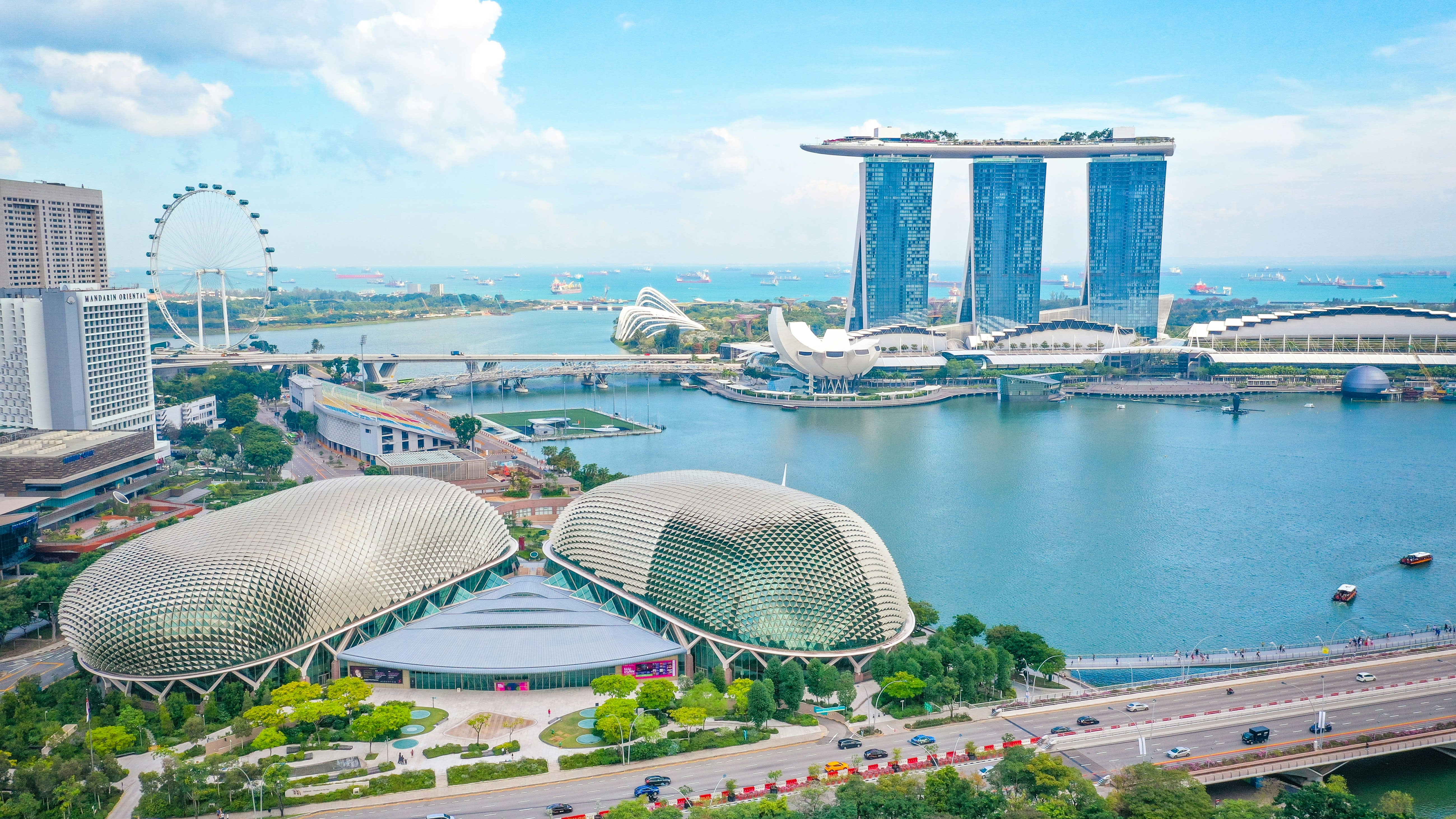 Aerial view of Singapore’s Marina Bay, featuring the durian-shaped Esplanade theatres in the foreground, Marina Bay Sands with its three towers and rooftop SkyPark in the background.