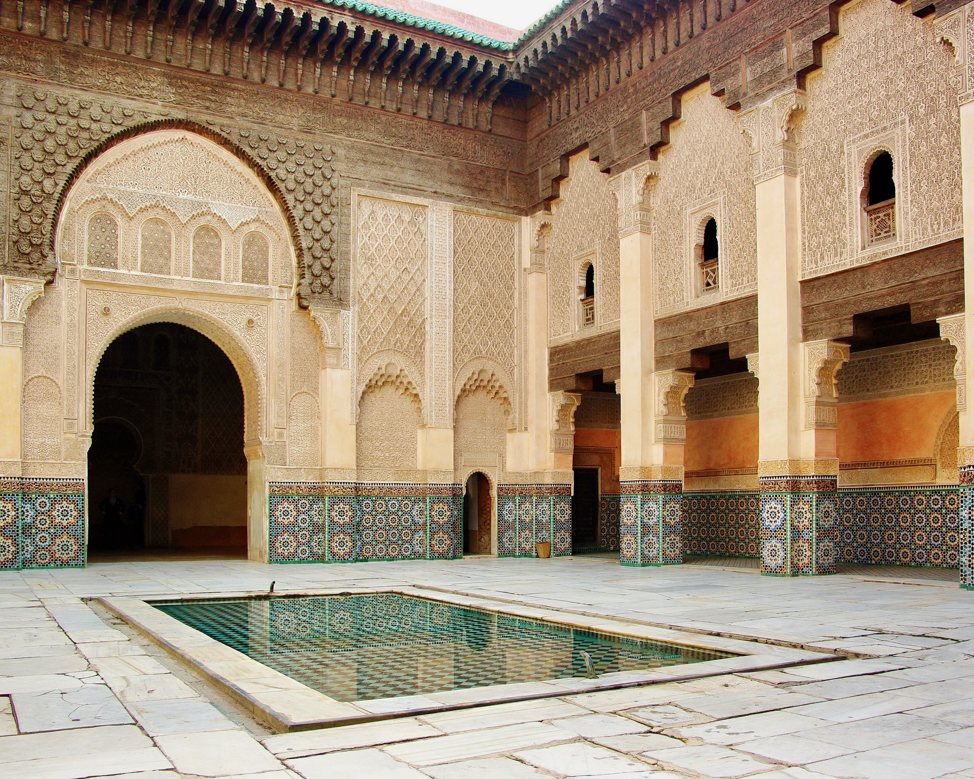 interior courtyard with reflecting pool and ornate turquoise, cream and brown tile walls
