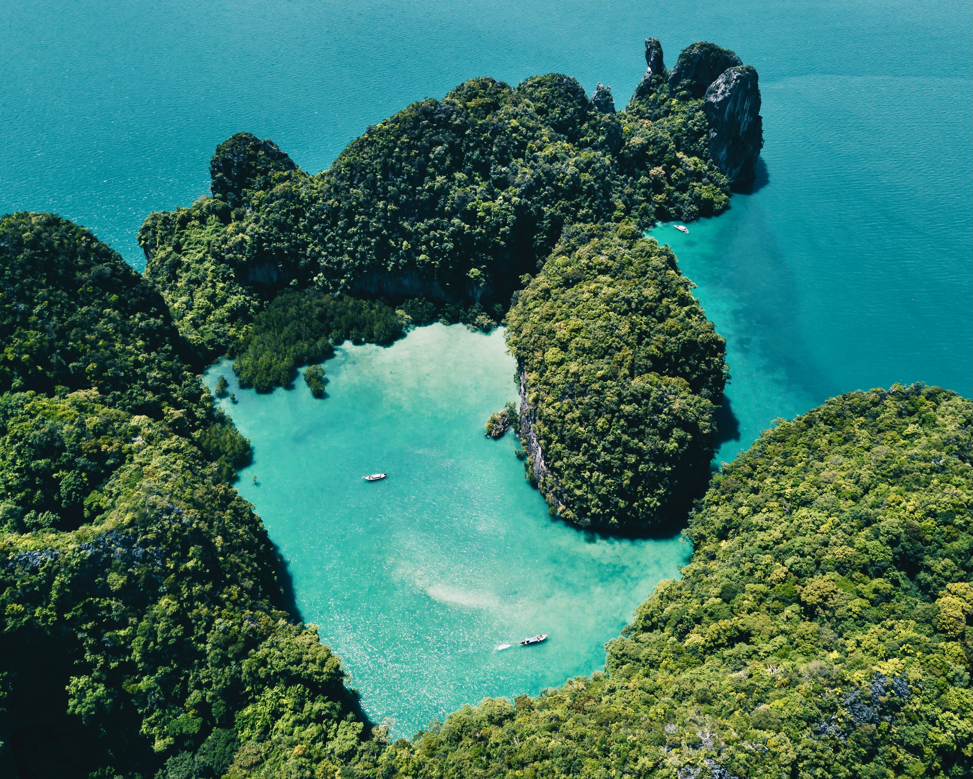 aerial view of a tropical green island with turquoise ocean waters