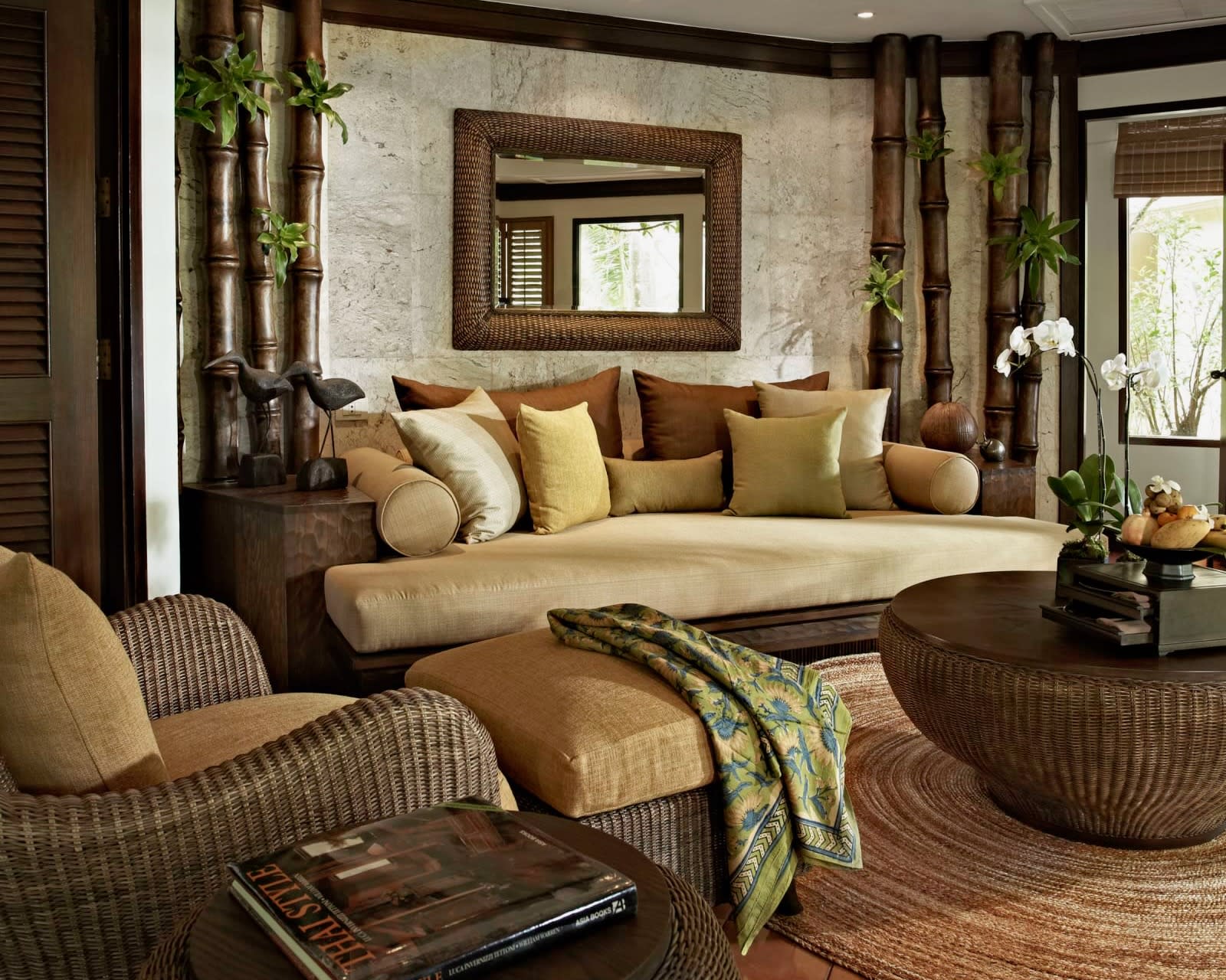 tropical living room with white walls, dark wood furniture, and tan colored fabrics