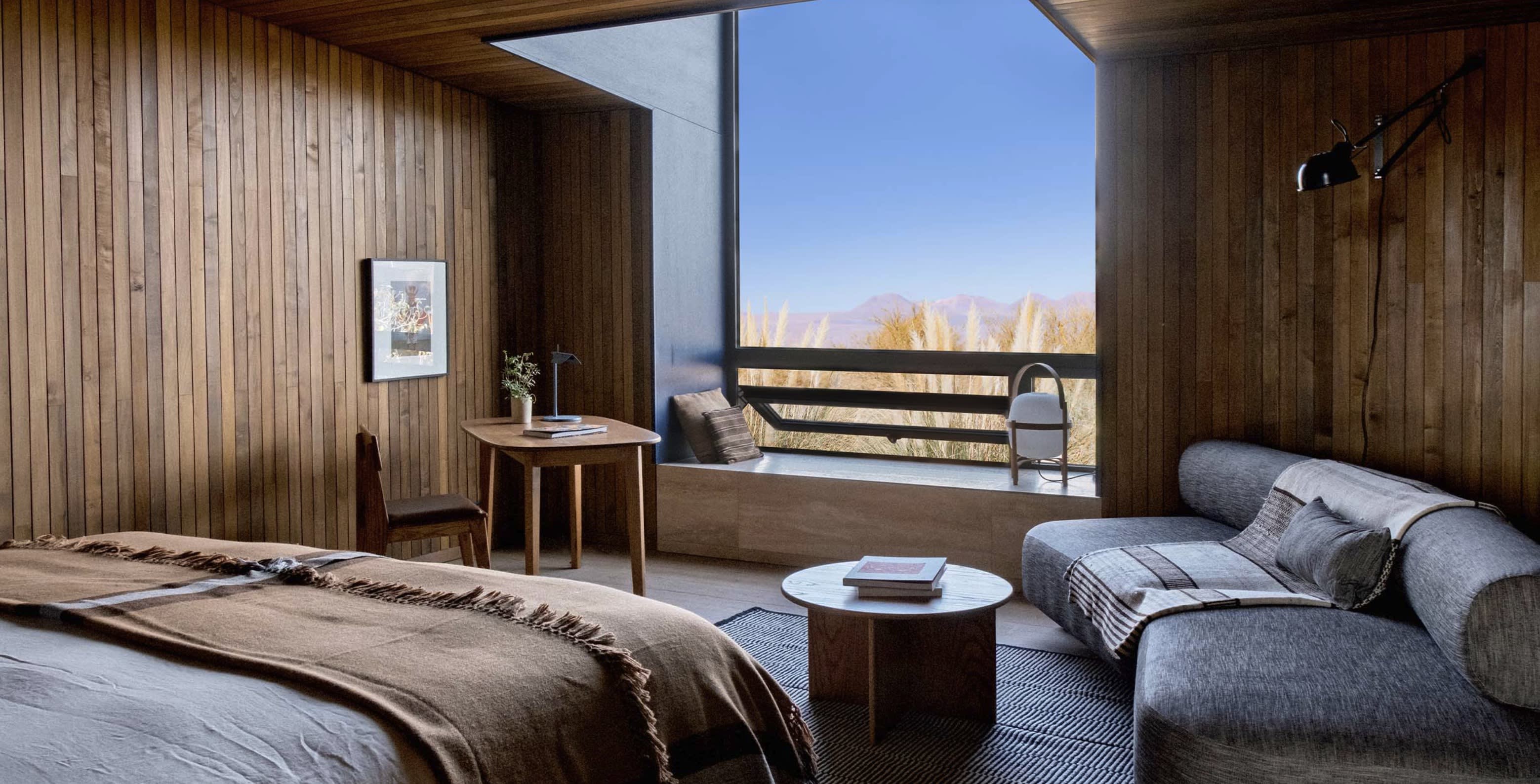 serene room with wood paneling and a desert view